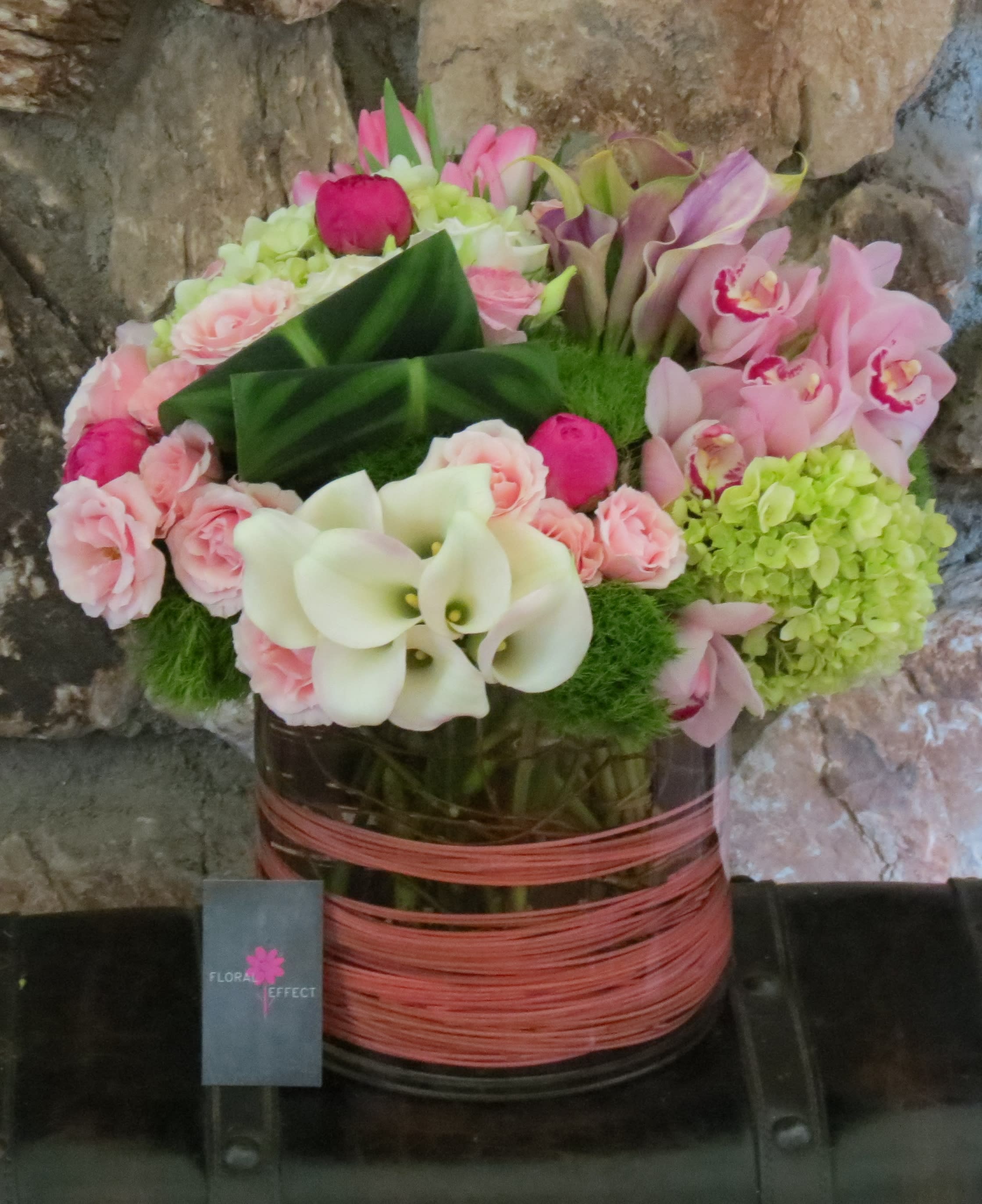 Calla lilies, cymbidiums, and peonies - An assortment of only premium flowers. Calla lilies, cymbidiums, peonies, tulips, hydrangeas, and spray roses, arranged in a glass vase
