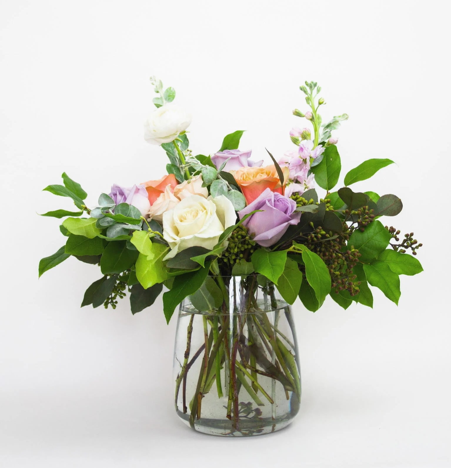 23 | monet - A classic clear vase with beautiful pastel flowers and foliage.