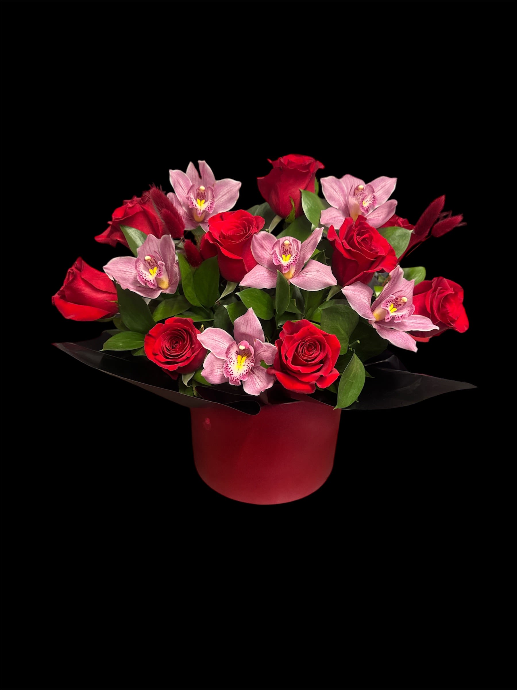 Lovely Life Lovely Life - Lovely life presents a sophisticated blend of pink orchids and red roses, creating an exquisite piece for any special moment.