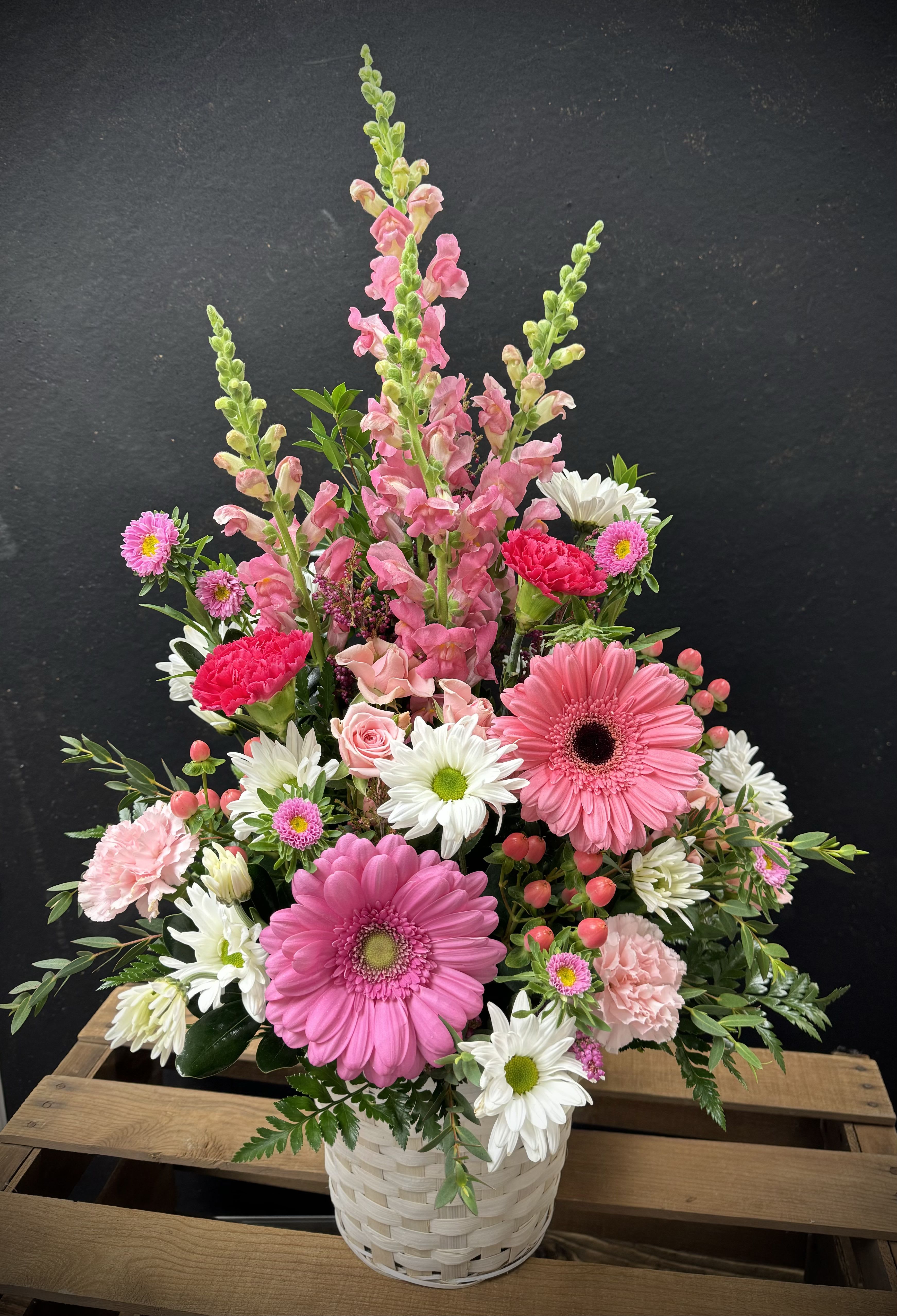 Pink Passion Basket - Basket of beautiful pink blooms accented with sprays of white. Flowers will be chosen upon what is available at the time for delivery. If you'd like a different color combination please leave us a note and we will do our best to accommodate you. 