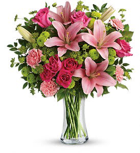 Telefora's Dressed To Impress Bouquet - This fabulously feminine bouquet features hot pink roses, hot pink spray roses, pink asiatic lilies, pink carnations, green button spray chrysanthemums, bupleurum, huckleberry and lemon leaf. Delivered in a clear glass vase. Approximately 17 1/2 W x 20 H