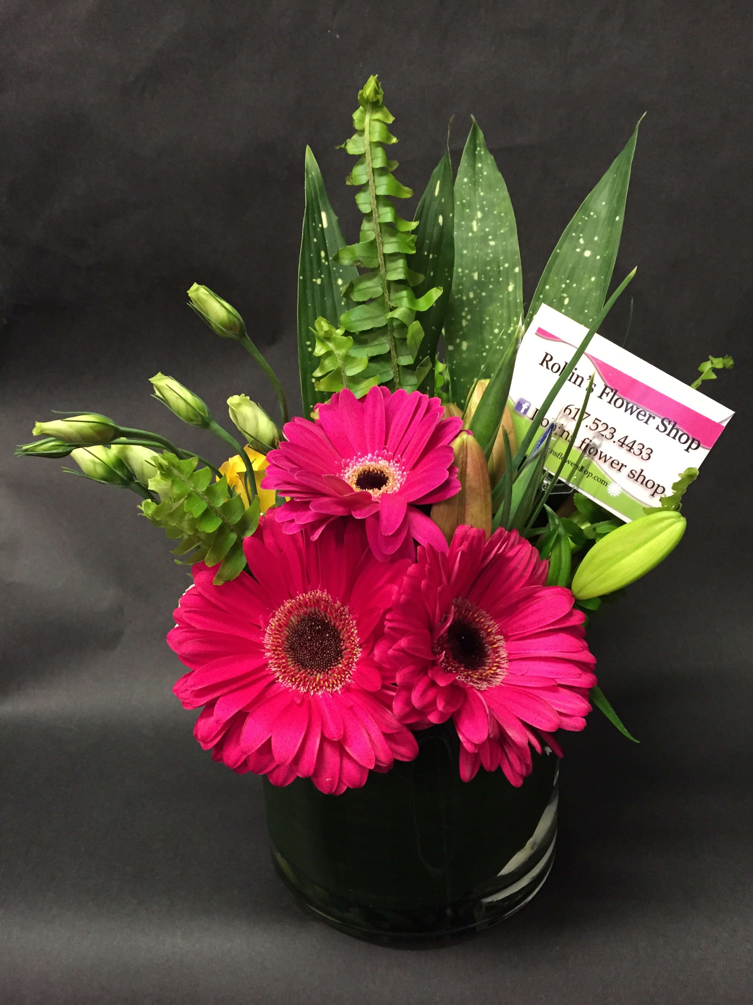 Flirty Gerty - Pop with affection as does this bold fuchsia gerbera daisy arrangement as it is surrounded by warm greens