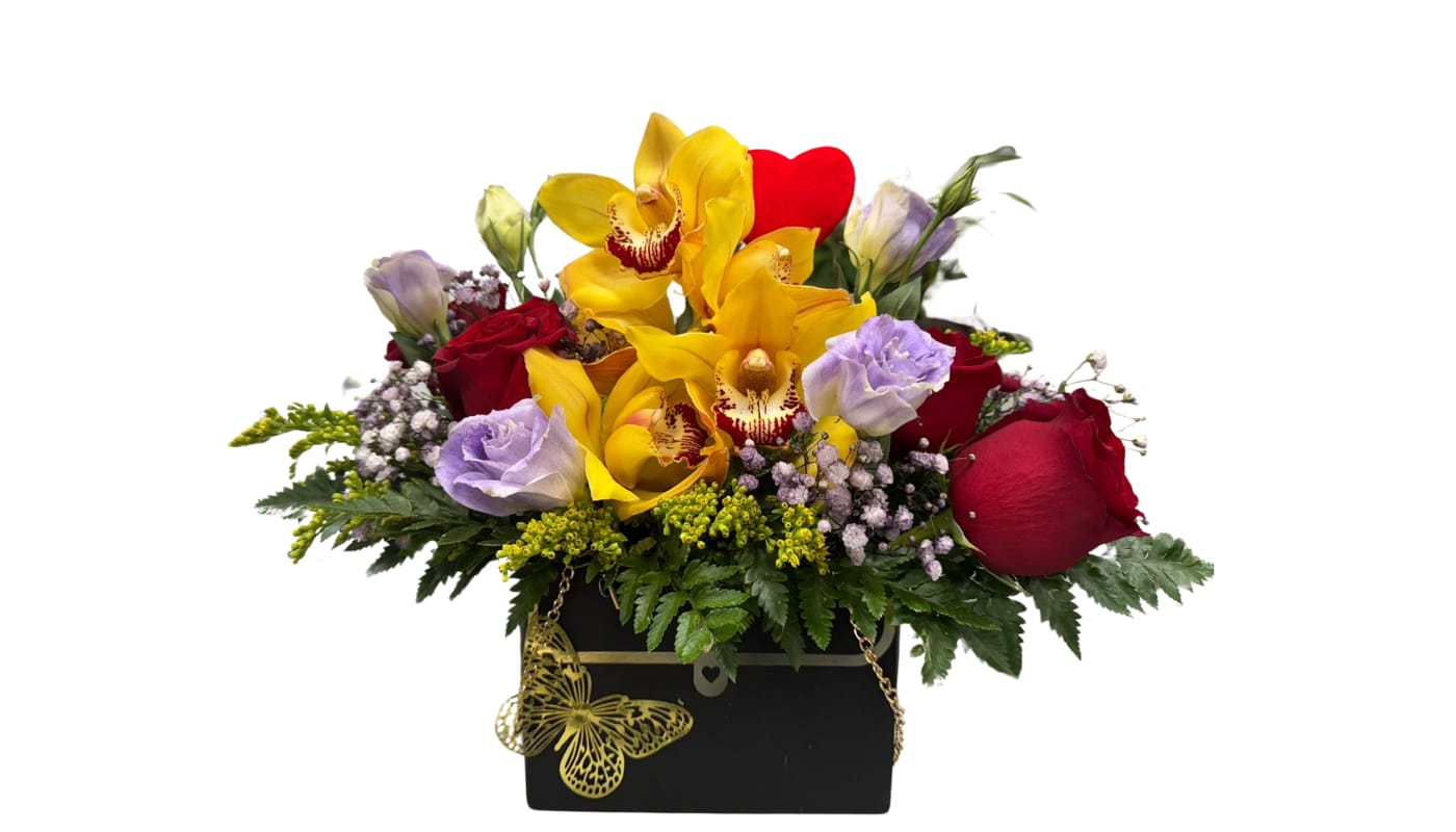 Toque de Encanto Toque de Encanto - Beautify your special moments with Touch of Charm, a sophisticated floral purse that combines the intensity of red roses, the exotic elegance of orchids and the charming subtlety of lisianthus.Flower variety depends on the season