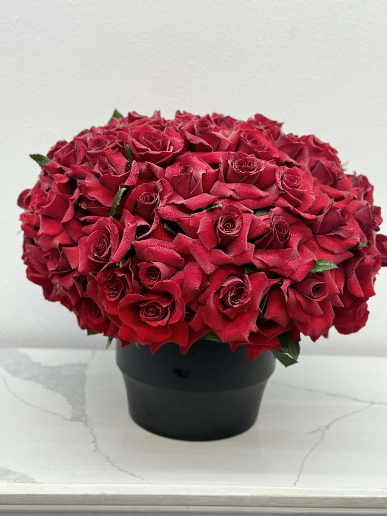 Passion in a Vase  - Introducing **Passion in a Vase**, a breathtaking arrangement that showcases beautifully handpicked red roses, expertly designed by our specialty team to create a one-of-a-kind masterpiece. This stunning bouquet is crafted to make a bold statement, with each rose meticulously arranged to ensure a captivating view from every angle. The vibrant blooms radiate passion and elegance, making them the perfect centerpiece for any occasion. Whether gracing a dining table or brightening a living space, **Passion in a Vase** transforms any environment into a sanctuary of love and beauty. Experience the allure of this exquisite arrangement and let it speak volumes about your sentiments in a truly remarkable way.