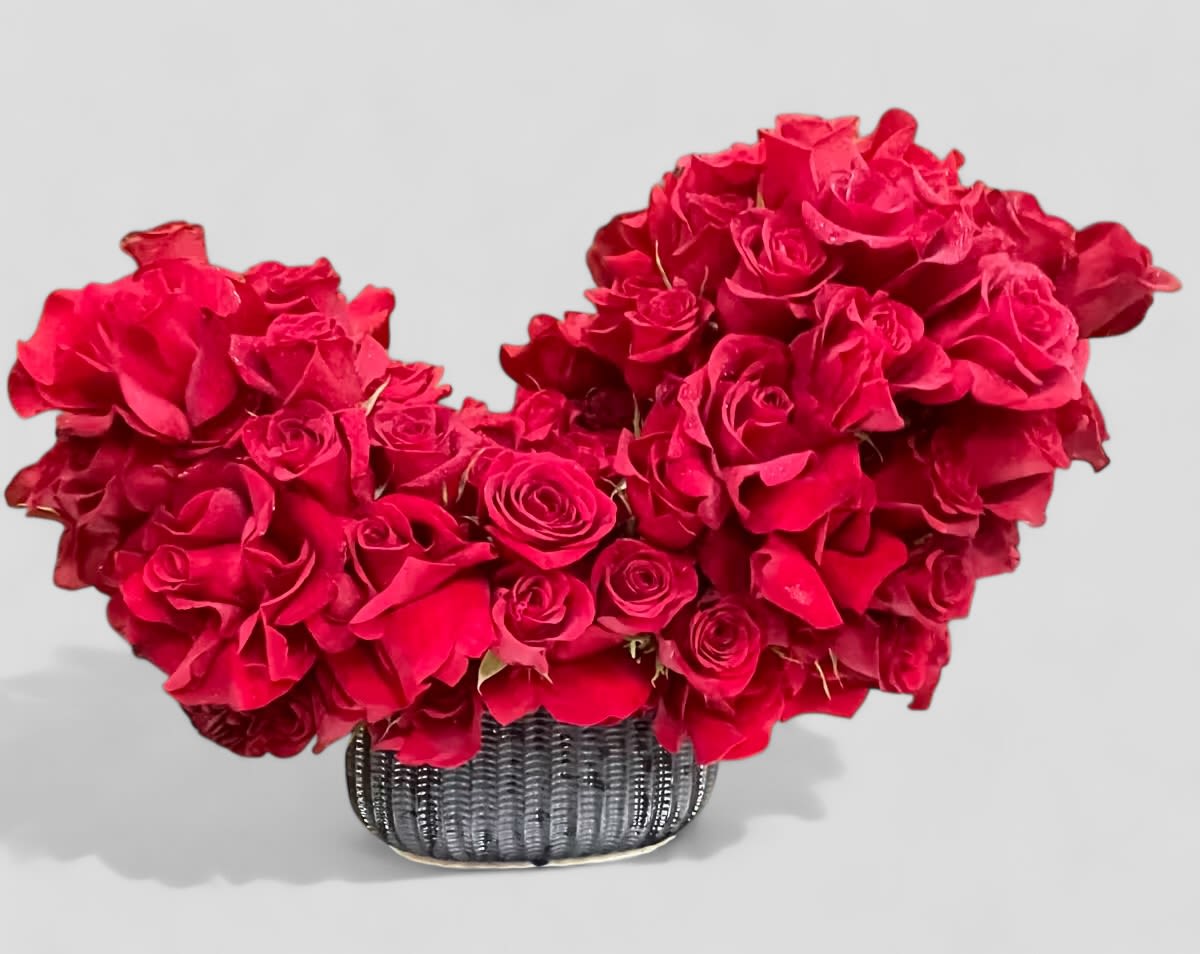 With Love - Large red roses in an asymmetrical heart-shaped arrangement.