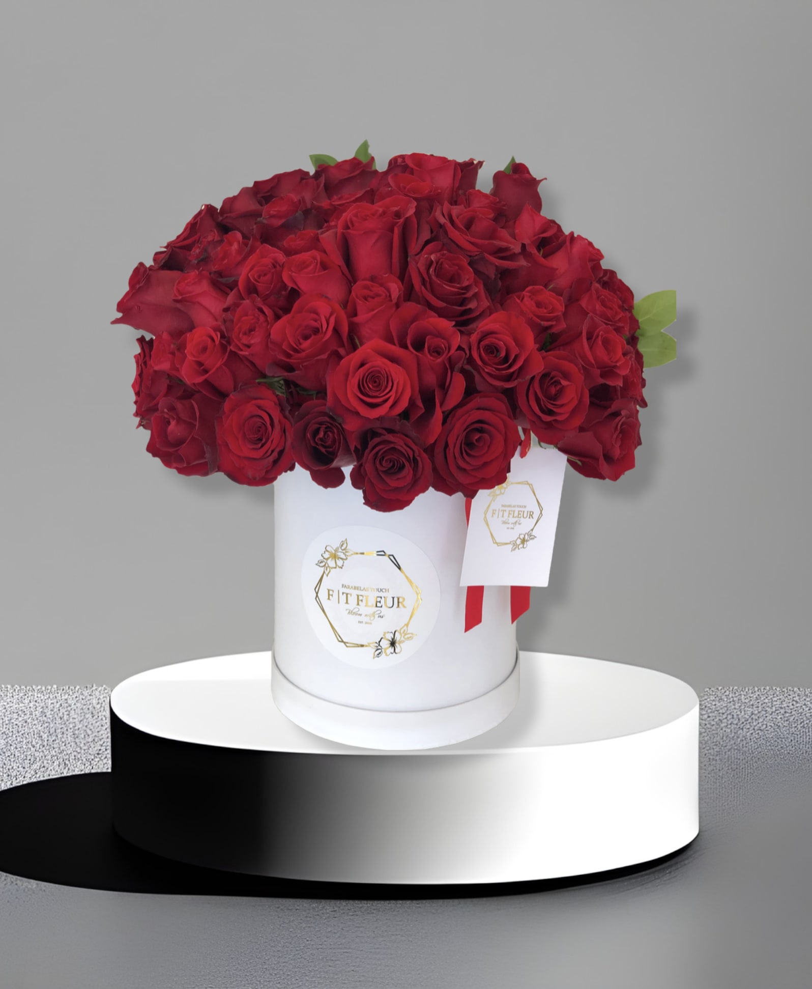 She’s has my heart  - Introducing **50 Red Roses in a Hat Box**, a stunning and whimsical arrangement designed to delight her senses. This beautiful display features 50 radiant red roses, thoughtfully arranged in a charming hat box that adds a playful touch to your heartfelt gift. Crafted by our skilled designers, this one-sided arrangement showcases the vibrant blooms in an eye-catching way, making it a perfect focal point for any space. Each rose is hand-selected for its freshness and beauty, ensuring a captivating presentation that expresses your love and admiration. Ideal for special occasions or simply to brighten her day, **50 Red Roses in a Hat Box** is a unique and enchanting way to convey your deepest sentiments, creating a memorable experience she'll cherish.