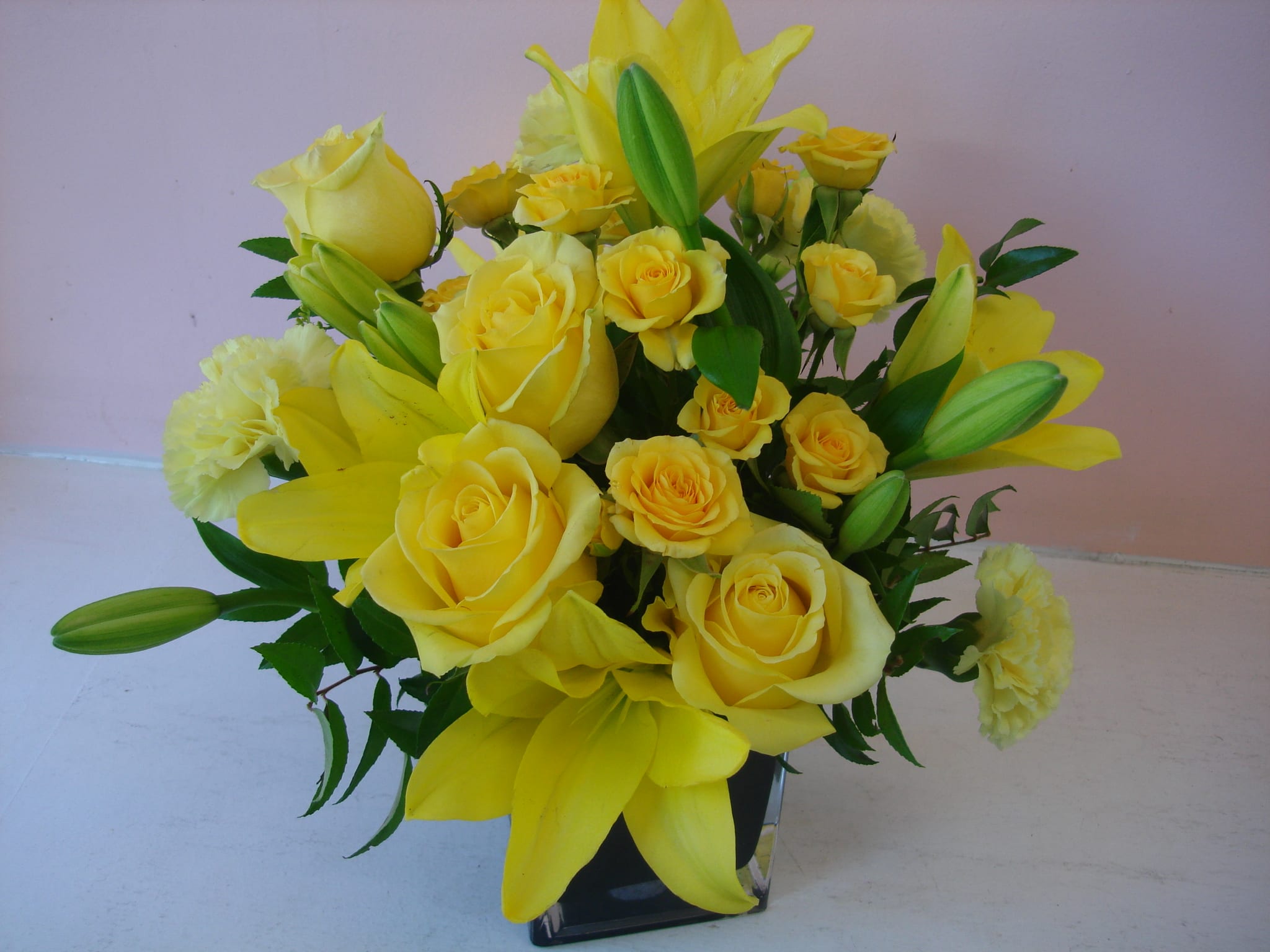All Yellow Flowers - W618 All Yellow Flowers - W618 - Do you like yellow flowers? Does he or she loves yellow flowers? If the answer is yes, this all yellow flowers is to order. All yellow flowers made with lilies, roses, spray roses and carnations. All these beautiful yellow flowers are arranged in clear cube glass vase. W618 has Dimension approximately 10"Hx7"W.