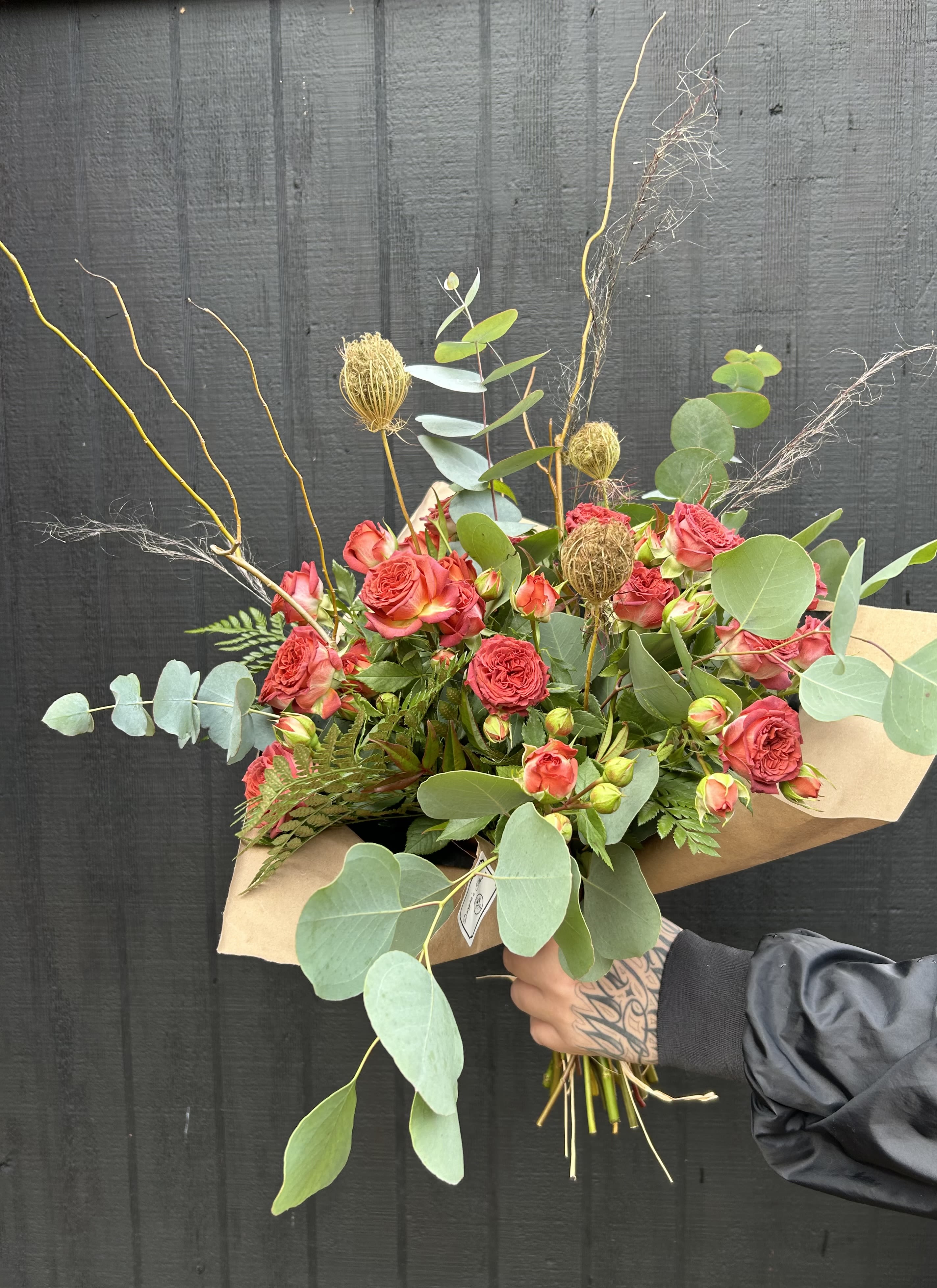 Wrapped. Garden Spray Rose bouquet - Garden Spray Roses with curly willow, a pod or queen lace, with pretty eucalyptus, fern, and dried grass. Wrapped in brown paper with ribbon bow. Other filler flower may be used due to seasonal availability but it will all have a similar look and feel.   *Let us know if you have a color you prefer. 