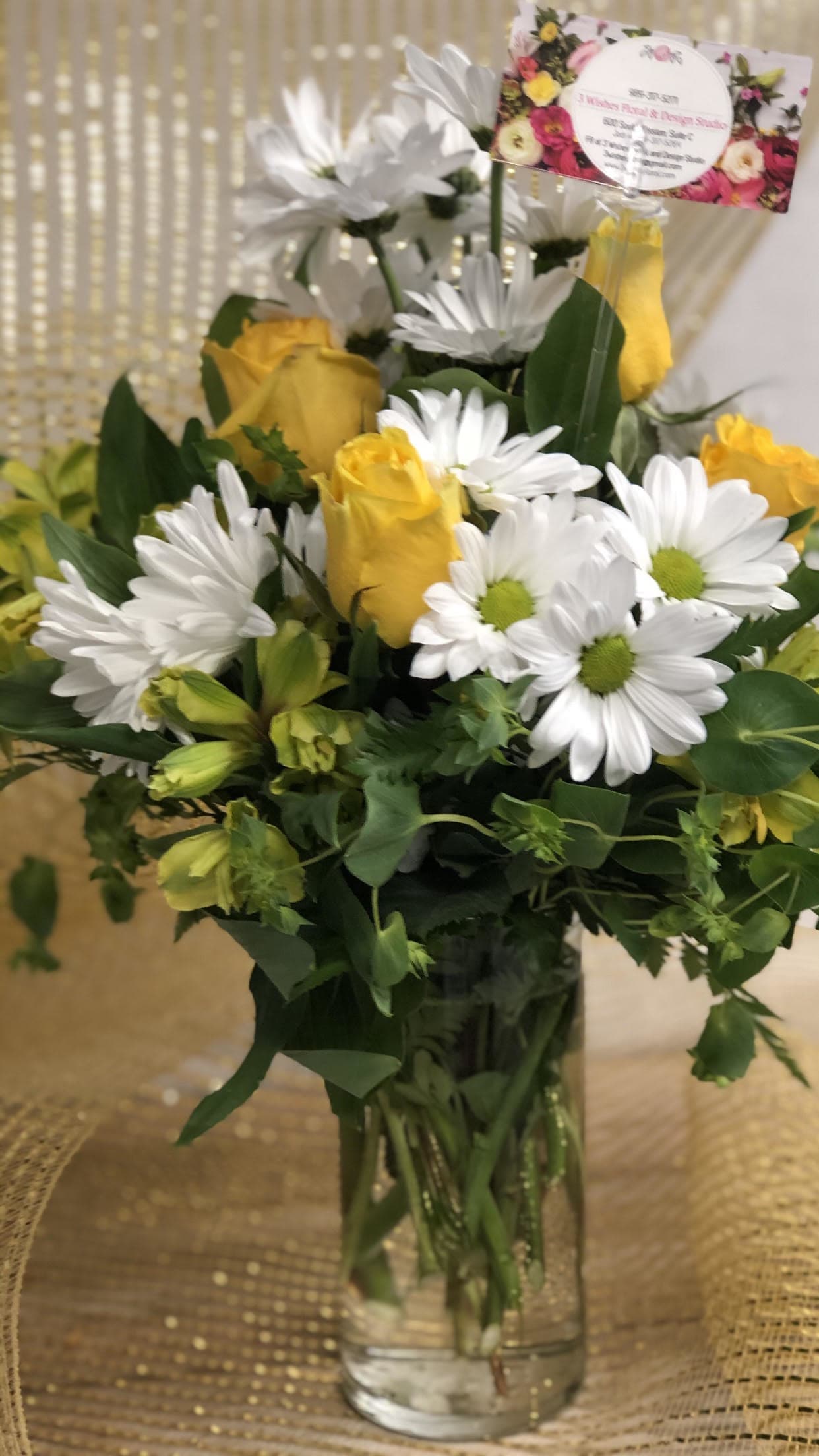 Sunny Wishes - A mix of white daises, yellow roses, and alstroemeria are sure to brighten anybody's day. 