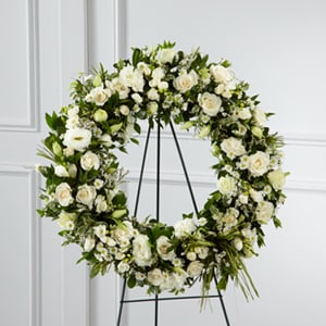 The Splendor Wreath -  Splendor Wreath is a symbol of lasting love and kinship whether for the deceased or in comfort of those suffering from a loss. Elegant white freesia double lisianthus spray roses monte casino asters and limonium are accented with a variety of lush greens and green raffia ribbon perfectly arranged in the form of a wreath to create a beautiful way to display your sincere sentiments.