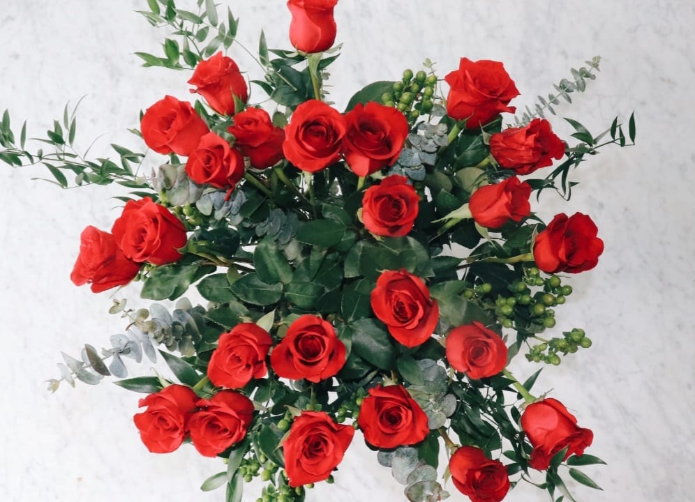 Two Rose Dozen Two Rose Dozen - Two long stem dozen roses of your desire color, complimented by richly textured greenery wrapped uniquely