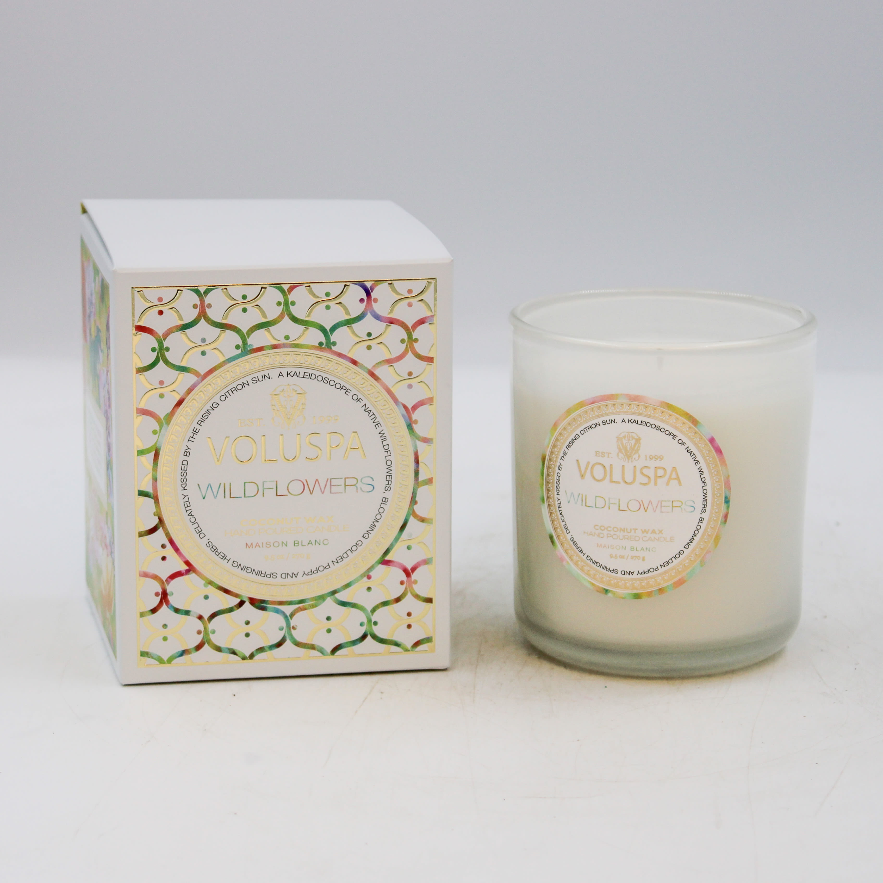 VOLUSPA Wildflowers boxed candle VOLUSPA Wildflowers boxed candle - DESCRIPTION Notes of Native Wildflowers, Golden Poppy, Springing Herbs & Soft Citrus. Fragrance Description You've been called to dance among the wildflowers, losing yourself in the beauty of this unruly floral sea. Lightly pass your hand over a kaleidoscope of Native Wildflowers, blooming Golden Poppy, Ambrosia and springing Herbs; sugared by misty vapors of Blue Agave and delicately kissed by the rising Citron sun. Gently coax this fragrant super bloom of Voluspa's Wildflowers. About the Product Voluspa's unique coconut wax blend is hand-poured into a 9.5 oz. pearl white glass and topped with a matching lid that keeps the candle dust-free when not in use, and doubles as a base when lit. The single wick allows you to enjoy fragrance throw for 60 hours. Our candles are hand-poured in the United States and feature our proprietary, clean-burning coconut wax blend and 100% natural wicks. Our products are free of phthalates, pesticides, parabens, and sulfates and are never tested on animals. Up-cycle this best seller into a keepsake after the last burn. FEATURES Product Details: Burn Time: 60 hours Fill (oz): 9.5 Fill (g/ml): 270 Natural Wick(s): 1 Vegan Free of phthalates, pesticides, parabens and sulfates Imperial Dimensions: 3.38" D x 3.75" H Metric Dimenions: 85.72 mm x 95.25 mm UPC: 806644081081 Collection: Maison Blanc Fragrance Family: Floral Explore Wildflowers