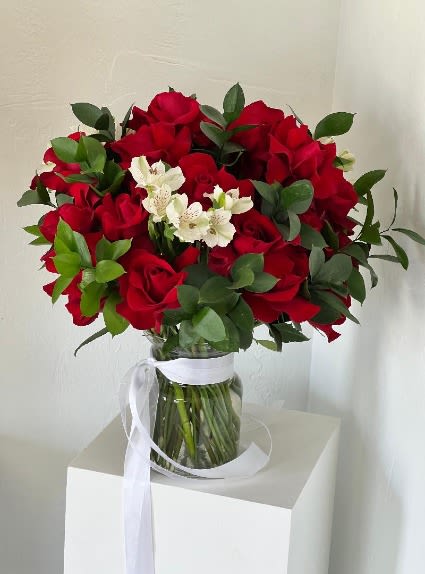 Touch of White - Extend an unforgettable romantic gesture with this red rose arrangement that features a hint of white alstroemeria for a stunning contrast. 