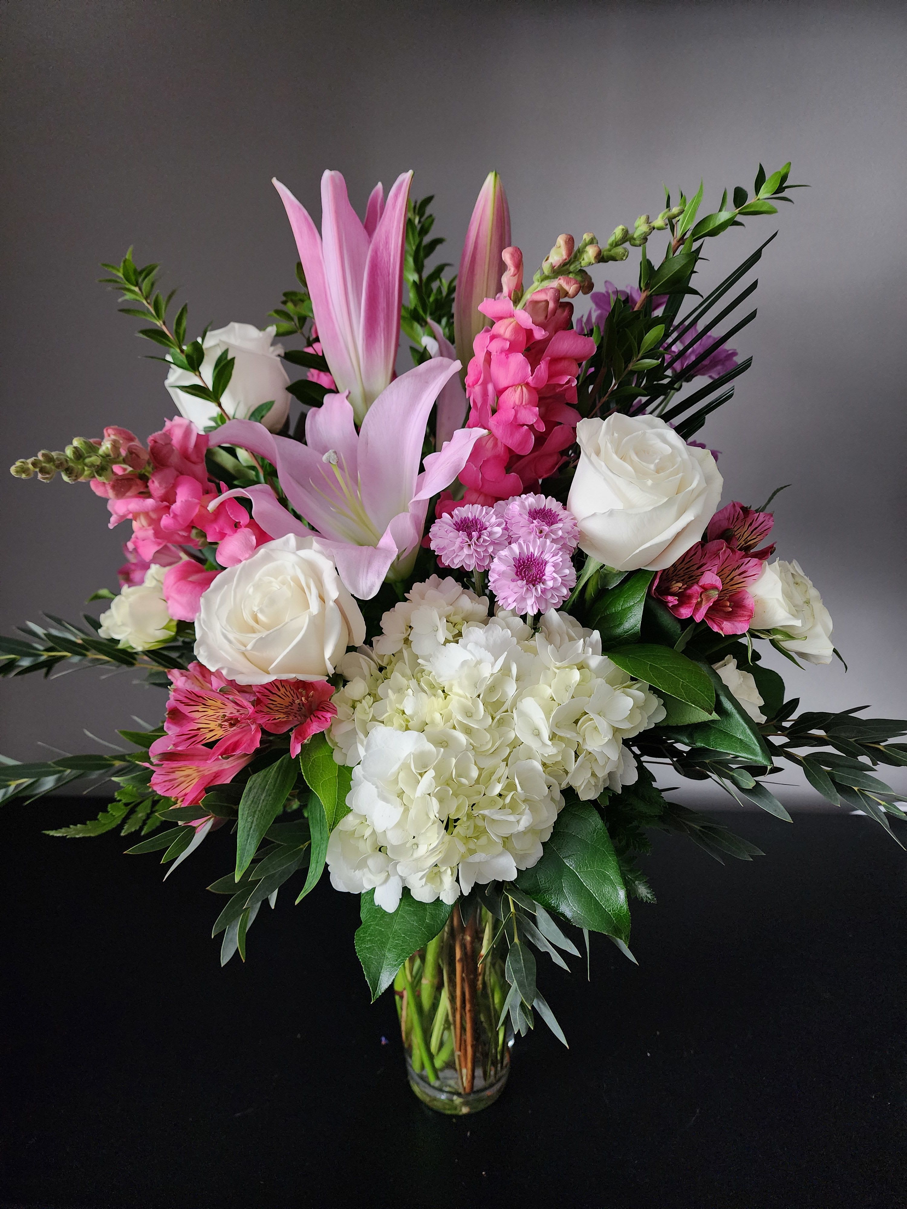 Romantic Gesture by MG Florist - This exquisite bouquet is sure to delight that special person.  Designed with hydrangea, snapdragons, roses, spray roses, alstroemeria, oriental lilies, daisies, button poms, and a variety of greenery.