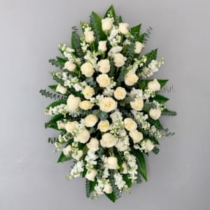 STANDING SPRAY WHTE STANDING SPRAY WHTE - This standing spray is a timeless expression of sympathy and love, designed to honor and celebrate a life well-lived. The arrangement's elegant blooms convey comfort, peace, and remembrance, offering solace to those who grieve while serving as a heartfelt tribute to cherished memories that will live on forever.