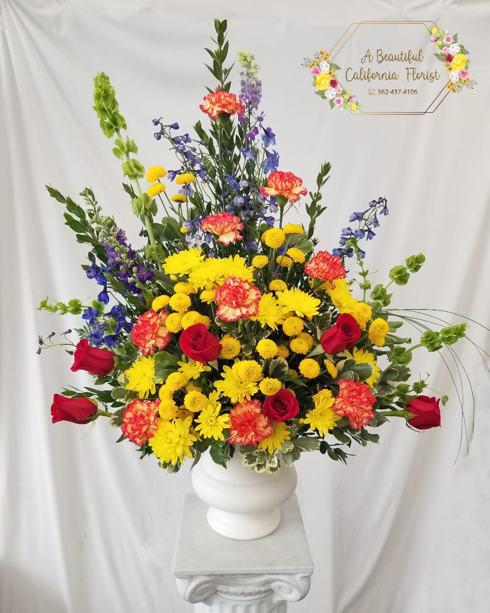 Celebration Tribute TMF-762 Celebration Tribute TMF-762 - A bright array of flowers combines to make a beautiful tribute. Approximately 20" wide by 26" high