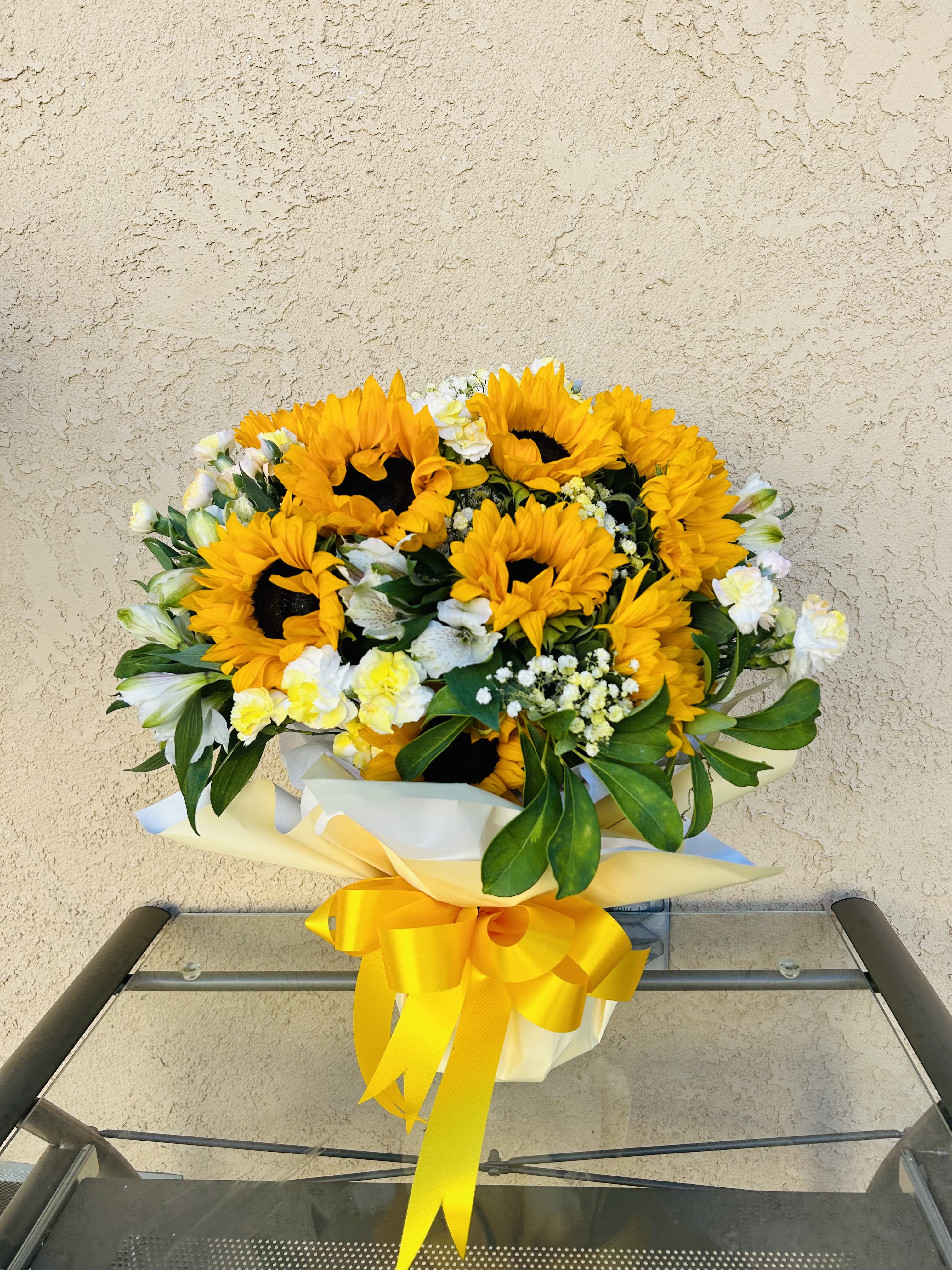 Golden Glow - Beautiful arrangement featuring sunflowers, carnations, baby breathe, and green accents