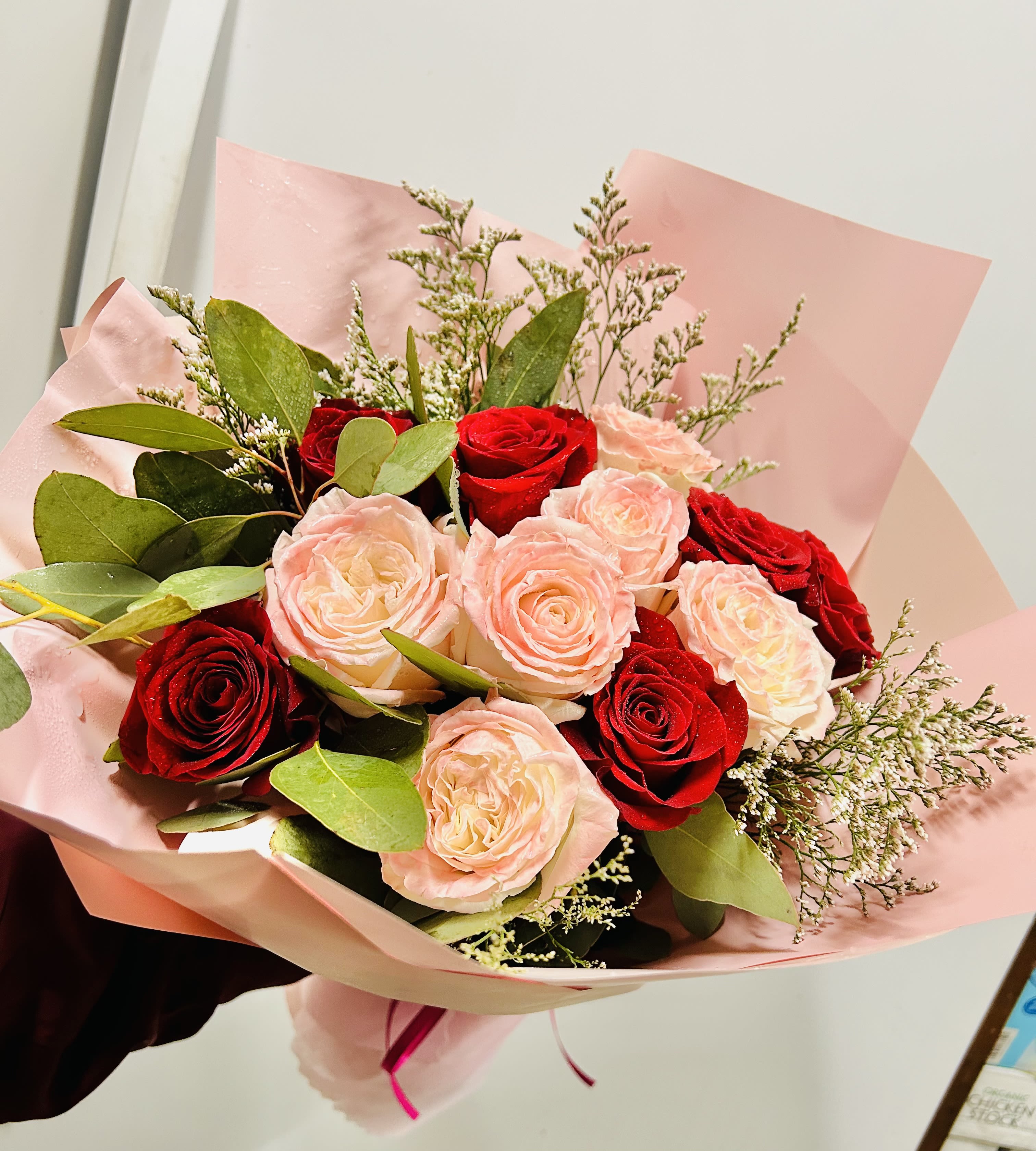 Always Yours - Beautiful bouquet of red and pink roses with green accents.