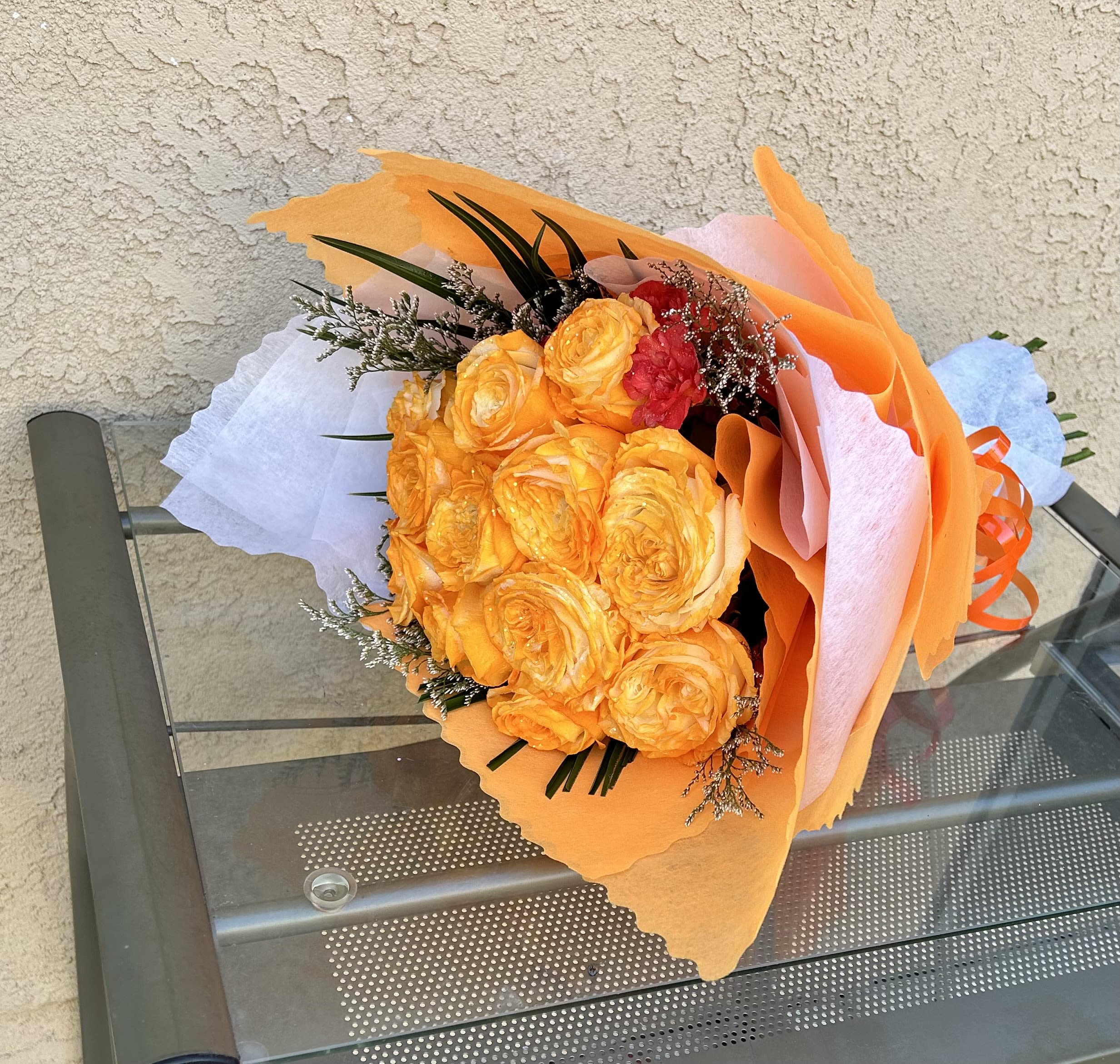 Heartstrings - Beautiful bouquet of vibrant orange roses and green accents.