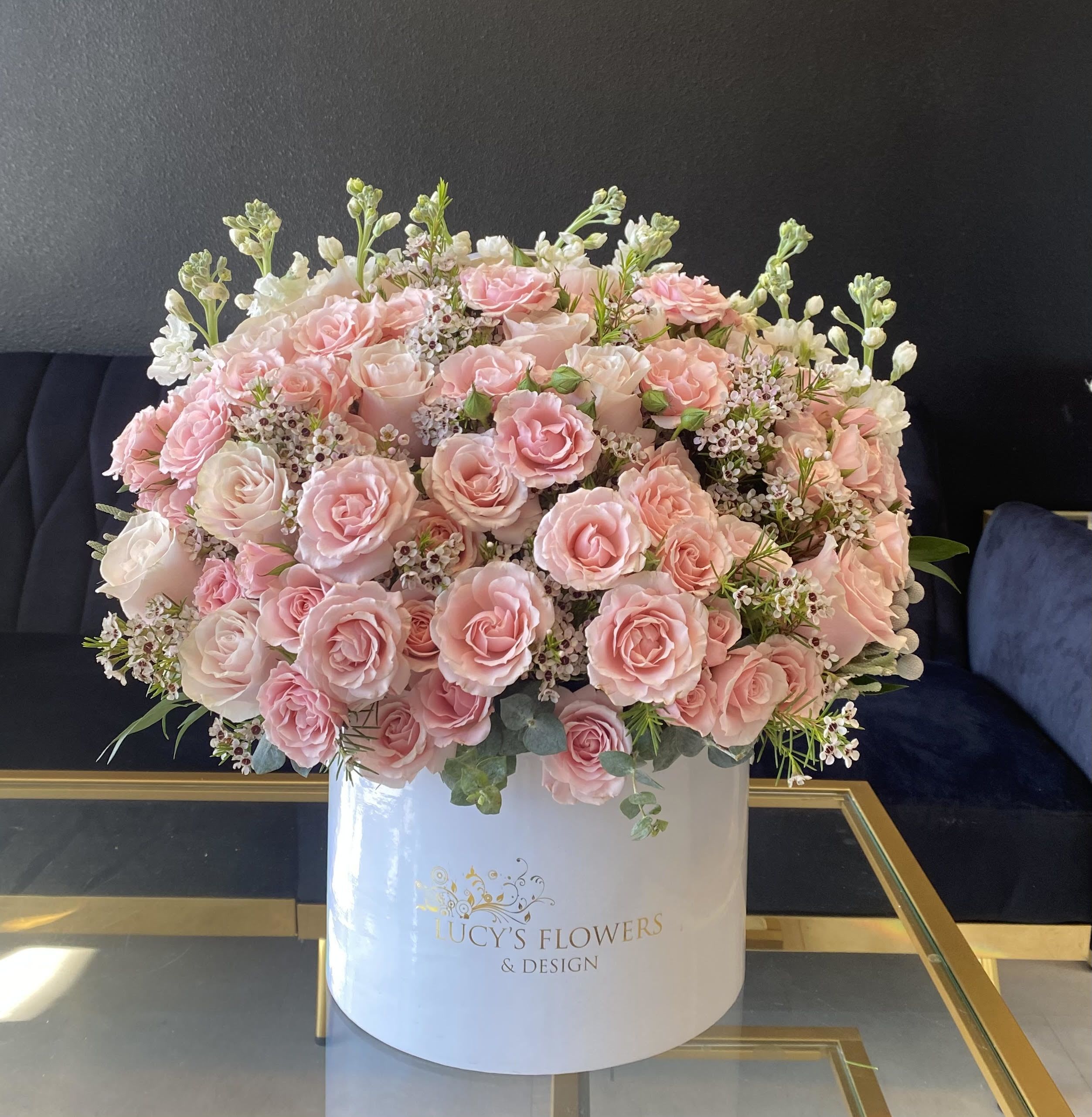 Precious Pink - This beauty designed with the most soft color of roses in a glossy Lucy's Flowers &amp; Design signature box, will surely make someone smile. It is the perfect gift for a birthday, thank you, or just because.   Arrangement Includes: -Fresh Cut Pink Mondial Roses, spray roses and other flowers  -Lucy's Flowers &amp; Design Medium box (9.75&quot; Dia. x 9.25&quot; H) -Custom Greeting Card Care Instructions
