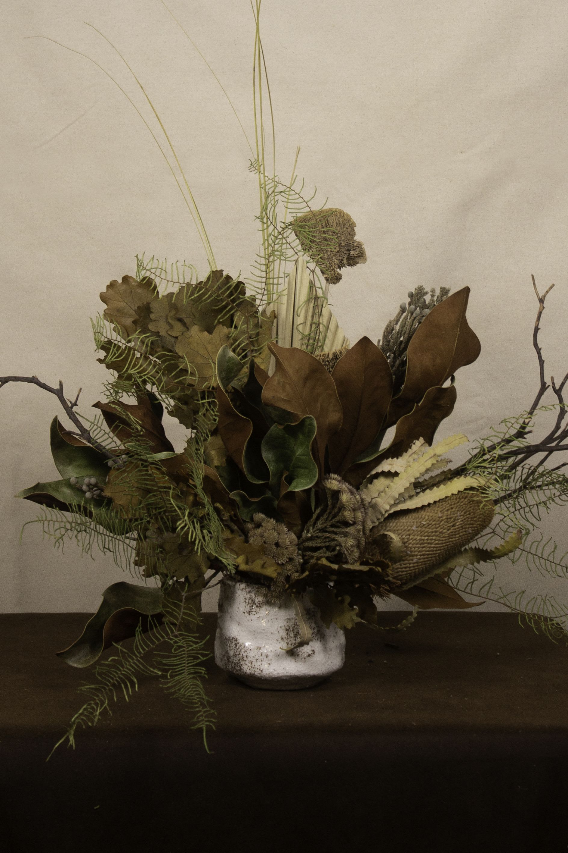 Bagan (Dried Flower Arrangement) - The timeless beauty of Bagan is captured in this dried flower arrangement, blending earthy tones and textures that evoke the ancient city’s sunlit pagodas and serene landscapes. Featuring warm hues, rustic grasses, and preserved blooms, this piece reflects the elegance of history and nature in harmony.   ---------------------- At The Burmese Cat Floral Studio, we celebrate the uniqueness of every flower and vase. While the photo captures the spirit of your arrangement, some elements—like one-of-a-kind vessels or seasonal stems—might not always be exactly the same. However, each arrangement will embody the same charm, elegance, and artistic flair.  If substitutions are needed due to weather, seasonal shifts, or market availability, we’ll stay true to the mood, colors, and style you’ve chosen. Rest assured, any replacements will match or exceed the value of the original design.  If there’s something specific that’s a must-have for your arrangement, just let us know in the notes at checkout or reach out directly—we’ll do our best to make it happen! ----------------------