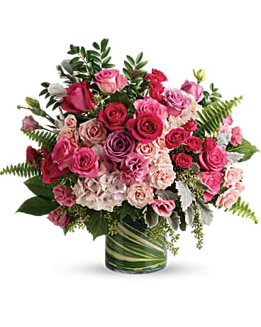 Haute Pink Bouquet by Teleflora - A high-fashion fantasy of roses! When you want to make a grand statement, send this dreamy bouquet of posh pink roses and modern greens. This gorgeous bouquet includes light pink hydrangea, hot pink roses, lavender roses, pink roses, hot pink spray roses, light pink spray roses, dusty miller, huckleberry, sword fern, seeded eucalyptus, lemon leaf, and variegated aspidistra leaves. Delivered in a large glass cylinder vase.