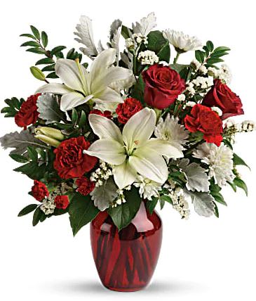 Vision of Love Vision of Love - A vision of love! This luxe bouquet of fragrant white lilies and radiant red roses, hand-delivered in a ruby vase, is the perfect expression of your feelings. This beloved bouquet includes red roses, white asiatic lilies, red carnations, red miniature carnations, white cushion spray roses, white sinuata statice, dusty miller, huckleberry, and lemon leaf. Delivered in a ruby rose vase. Orientation: All-Around All prices in USD ($) Due to an increase in the cost of roses, some product prices may be impacted during the Valentine’s delivery period.