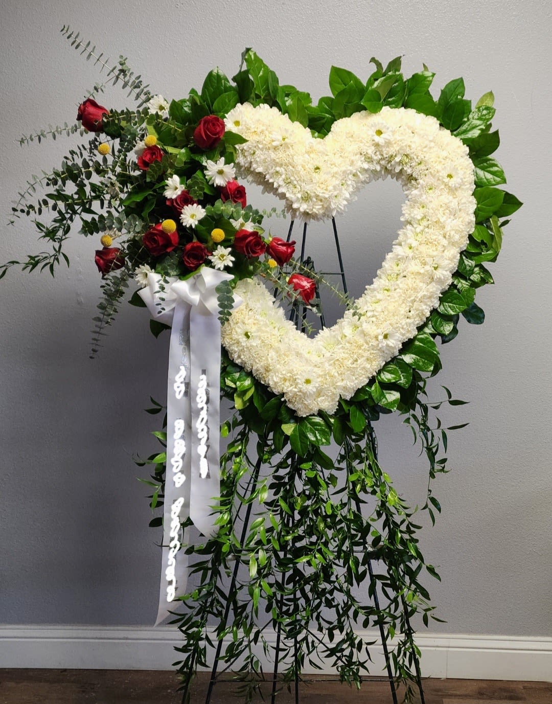 Love in Our Hearts - White carnations, white daisies, red roses and greenery.