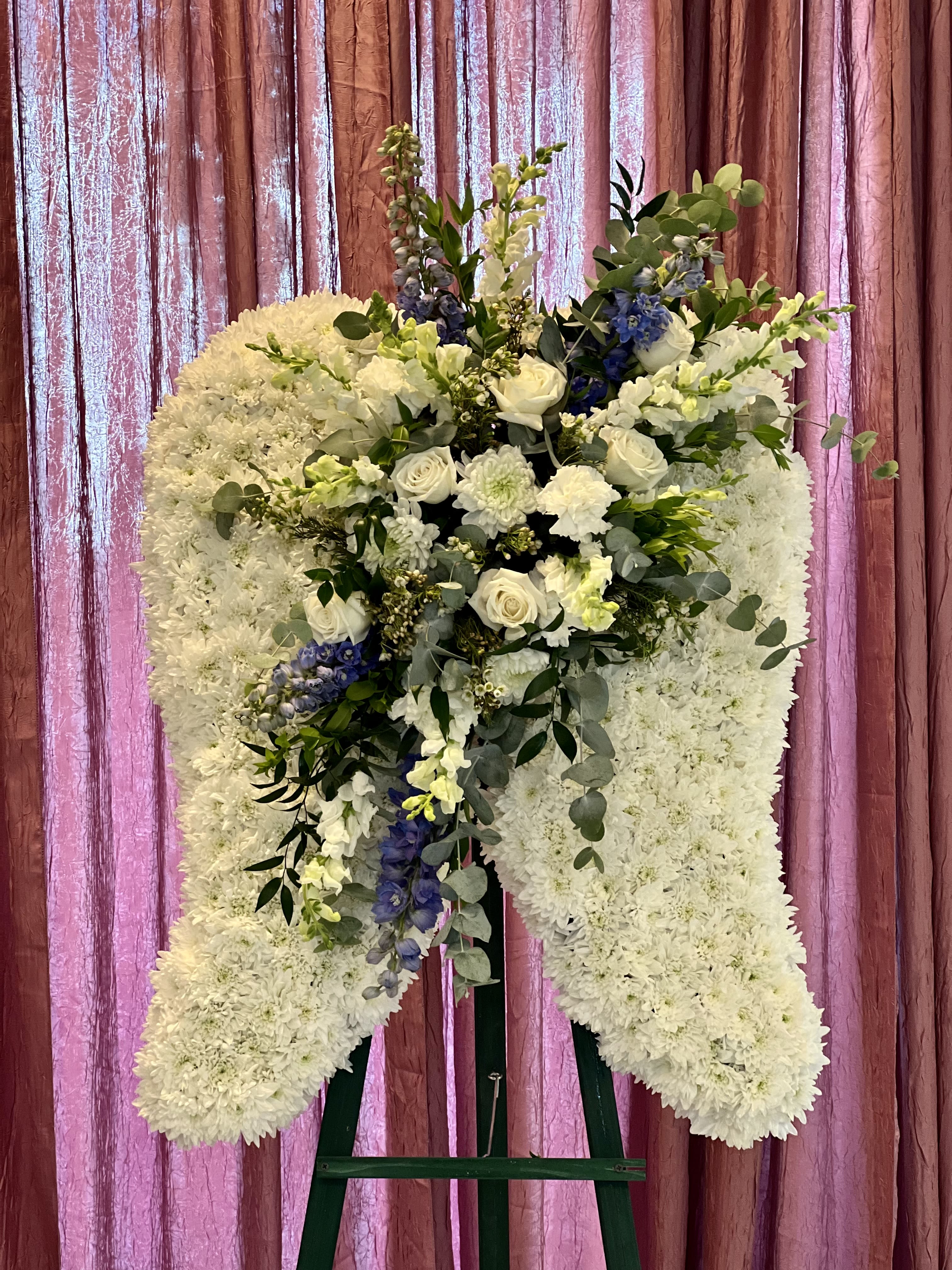 Angel Wings Angel Wings - Custom Angel Wings. Wings are filled with all white cushion mums and the cluster is made with mixed greens and white florals. *Please leave a note on color if other than white in the center.*