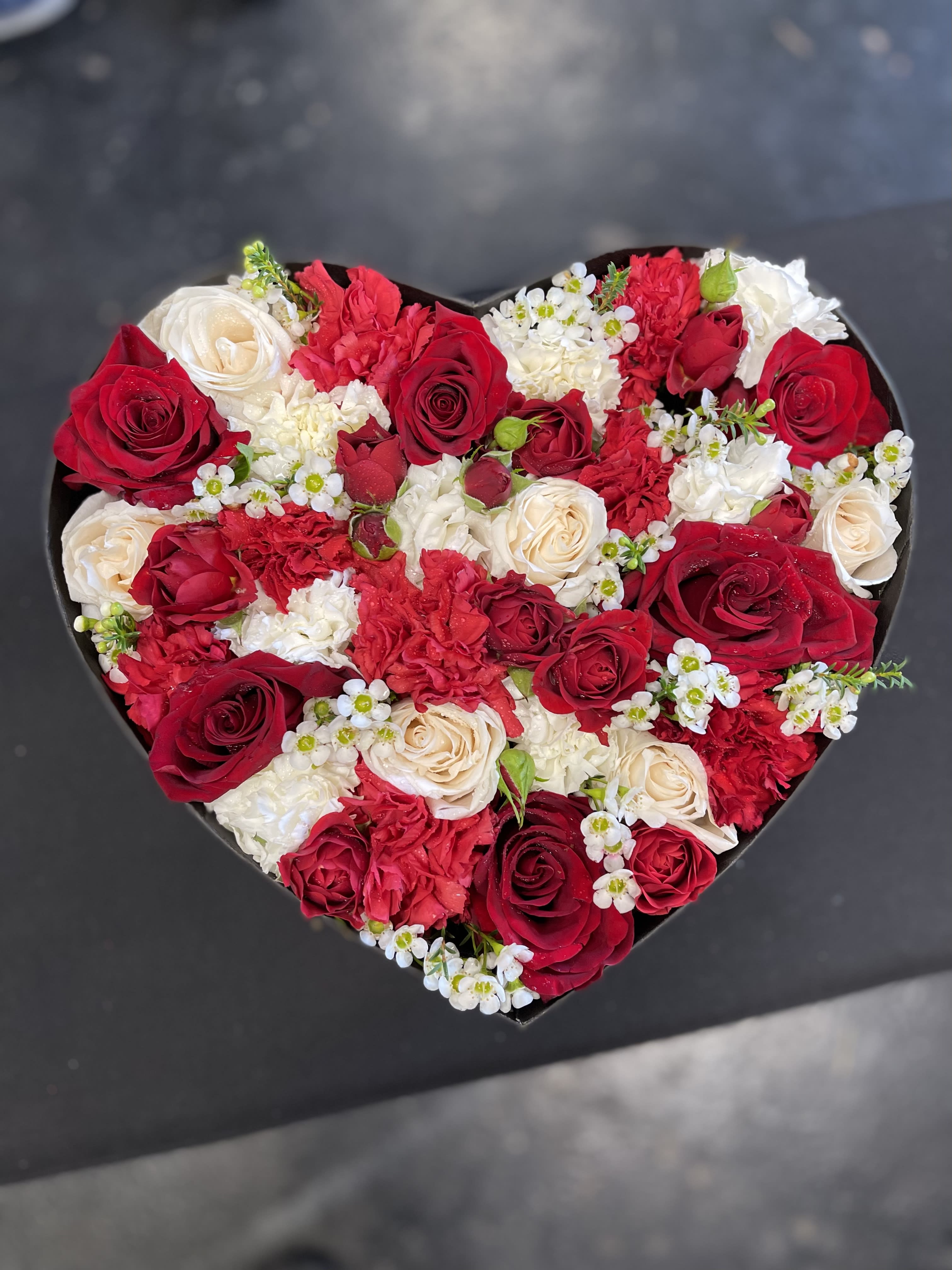 You can have my heart ! You can have my heart ! - Beautiful imported roses, spray roses wax, and carnations beautifully designed in a heart shaped box.