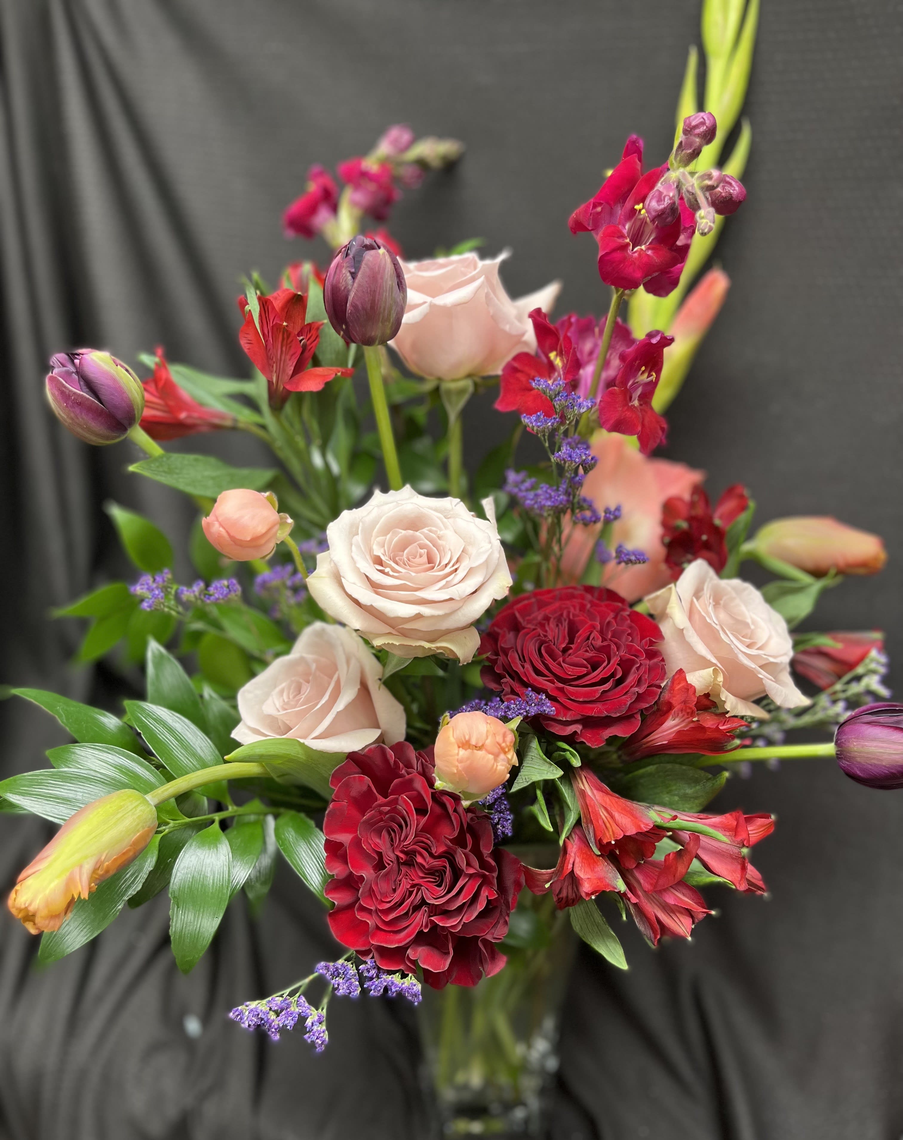 Two hearts Two hearts - This tall vase arrangement is made with our beautiful roses, gladiolas, tulips, and alstroemeria