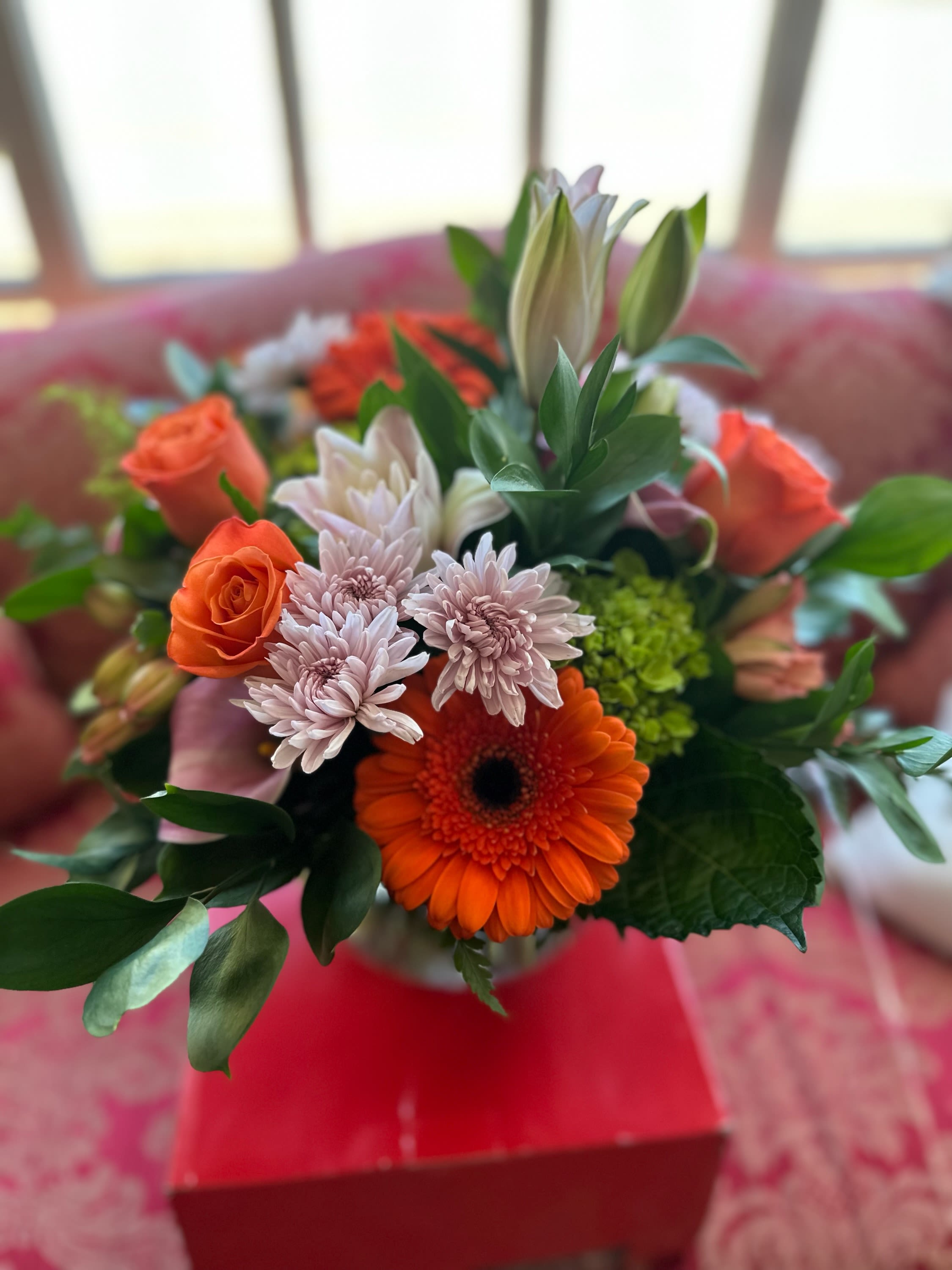 You're my desire Bouquet You're my desire Bouquet - Pink lilies, orange roses, gerbera, green hydrangea, pink alstromeria and lavender cushion poms designed in a vase
