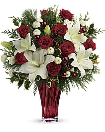 Wondrous Winter Bouquet Wondrous Winter Bouquet - Send them the wonders of winter with beautiful red roses, snow white lilies and fresh winter greens arranged in an elegant and unique glass vase. Red roses, white asiatic lilies and white button chrysanthemums are accented with fresh flat cedar, variegated holly, white pine, pinecones and red ornament balls.