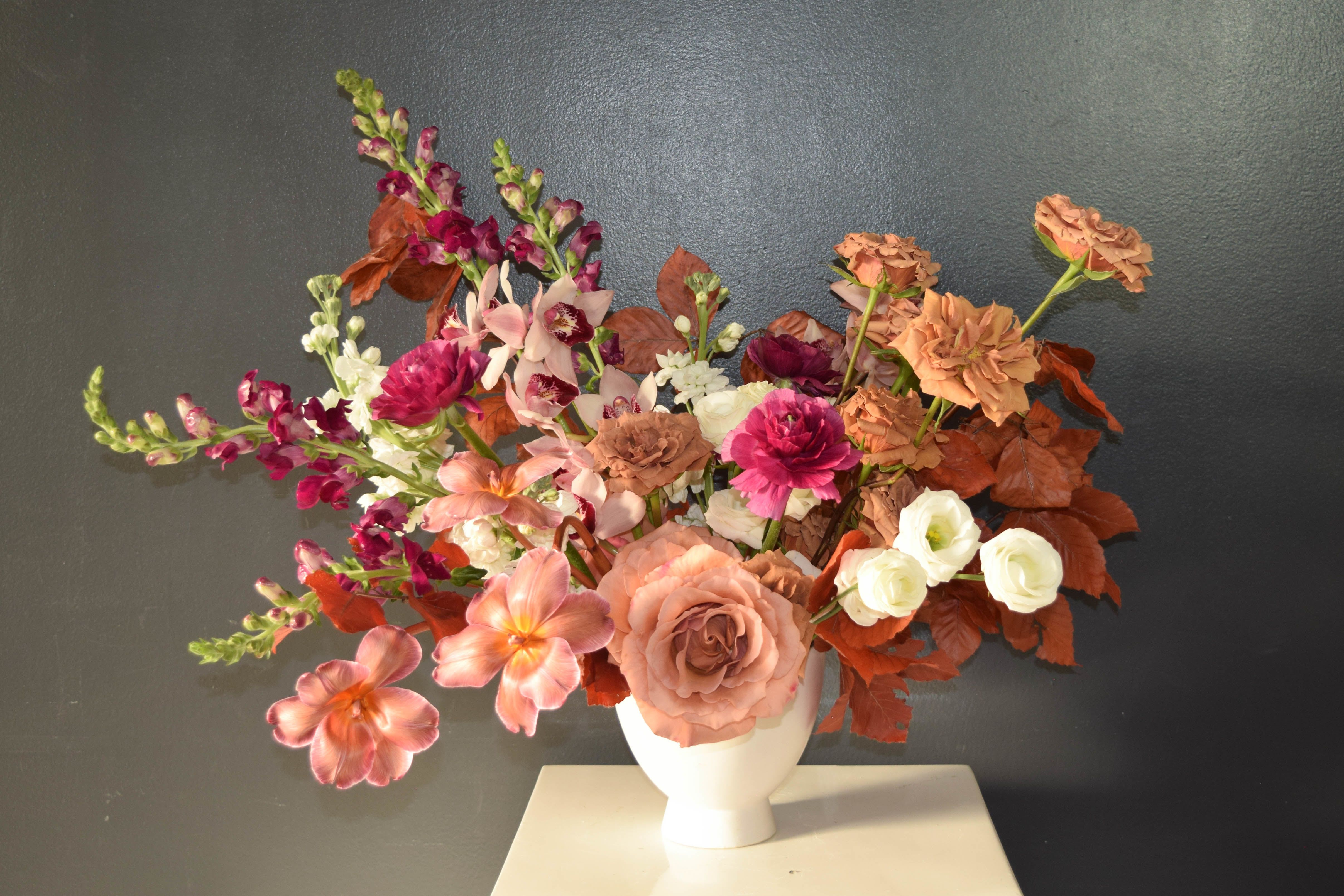 The Muse The Muse - Like it's namesake, this gorgeous pot arrangement is sure to delight and inspire. A chic combination of neutral tones and sculptural elements gives this arrangement a contemporary edge, ideal for a love that’s both classic and bold. Order by February 6th for a free add on chocolate! Please note that every arrangement is unique and will not look exactly as pictured here. For all orders with a timed delivery by 10 am or 12 pm add a priority delivery fee to your cart. Please contact the store for custom bloom or container requests, including using a personal container. We'd love to chat about your floral wishes!