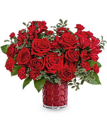  Radiant Hearts Bouquet - DESCRIPTION VASE SIZES As radiant as your love, this romantic Valentine's Day bouquet shines beautifully in a pearlescent vase adorned with an embossed heart pattern. This Valentine's Day bouquet showcases red roses, red spray roses, red alstroemeria, and miniature red carnations, complemented by lemon leaf and pitta negra. Teleflora's Radiant Hearts Bouquet is delivered in Teleflora's Enchanted Hearts Vase. Orientation: All-Around  SUBSTITUTION POLICY – Always deliver the freshest flowers! Please note the bouquet pictured reflects our original design.  If the exact flowers or container in this arrangement are not available, our local florists will create a beautiful bouquet with the freshest available flowers. 