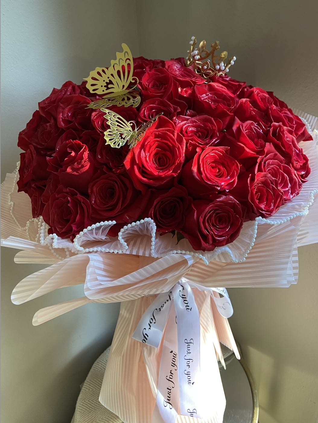 My Queen - The My Queen Bouquet is a regal, show-stopping gift designed to honor the queen in your life. Featuring an impressive eight dozen Ecuadorian-grown red roses, each rose is a symbol of love, beauty, and strength, radiating a deep, rich red that captures the essence of passion and admiration. These roses, known for their long-lasting beauty and velvety petals, are carefully arranged to create a dramatic, luxurious display that speaks volumes.  Wrapped in silky couture paper, the bouquet is presented with the kind of sophistication and elegance fit for royalty. The smooth, lustrous texture of the paper enhances the bouquet’s opulent feel, wrapping the roses in a way that makes them look even more striking.  This arrangement is more than just flowers—it’s a grand gesture that shows just how much you love and cherish her. The My Queen Bouquet is the ultimate way to make her feel like royalty, whether for a special occasion or just to show her she’s cherished every single day.   Do you want a different color of roses? Please text us and let us know (714)360-5020 