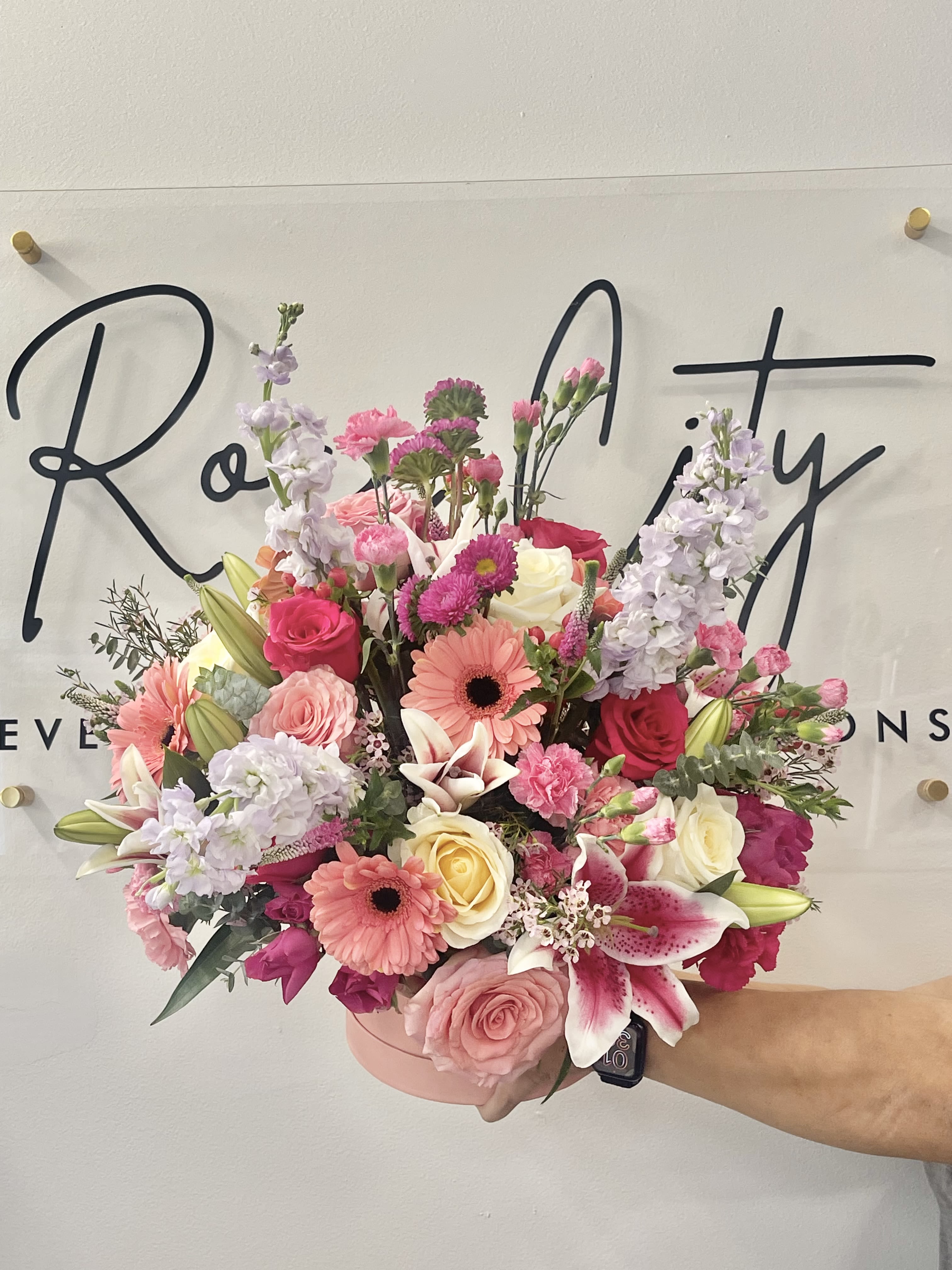 Get Your Pink On - This product was created in honor of Breast Cancer Awareness Month. We honor and show love and support to all the survivors and all going through this horrible disease. With this arrangement we show them how strong and resilient they can be.  With a mixture of roses, gerbera daisies, stock and lilies 