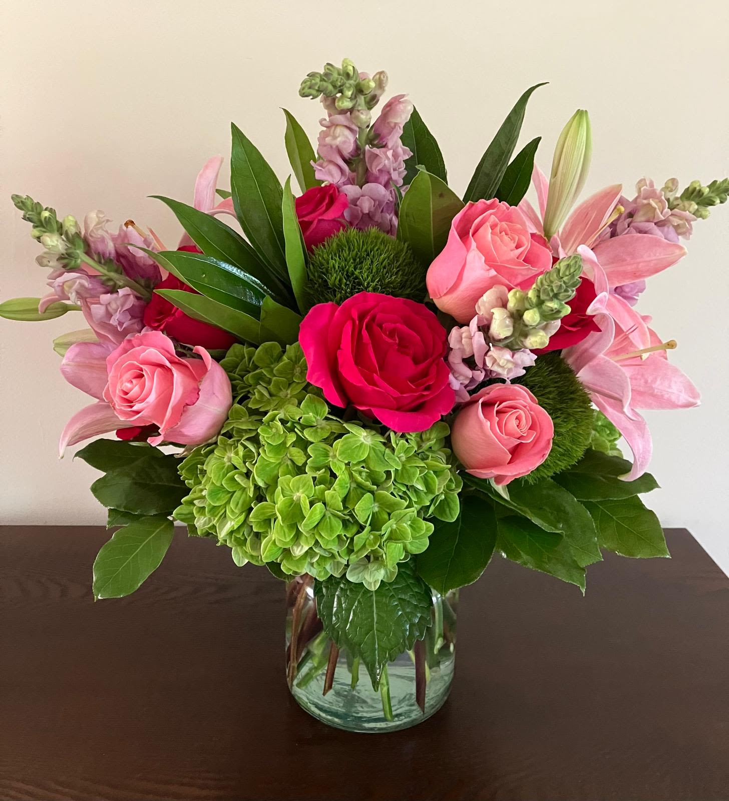 Laura Bouquet - All Occasion Glass Pot • Place your Order Online Monday to Saturday before 1:00 p.m. (E.T.) for same-day delivery. • “Orders received after hours will be delivered the next business day”. • Check our coverage area. • Occasionally, substitutions of flowers and/or containers happen due to weather, seasonality, and market conditions which may affect availability. If this is the case with the gift you’ve selected, we will ensure that the style, theme, and color scheme of your arrangement are preserved and will only substitute items of equal value or higher value.  CARE INSTRUCTIONS Keep the flower arrangement hydrated with natural water and change the water every two days. Do not spray any cleaning product on the flower arrangement. Do not place heavy objects directly on the flower arrangement. Keep flower arrangements out of direct sunlight and extreme heat.
