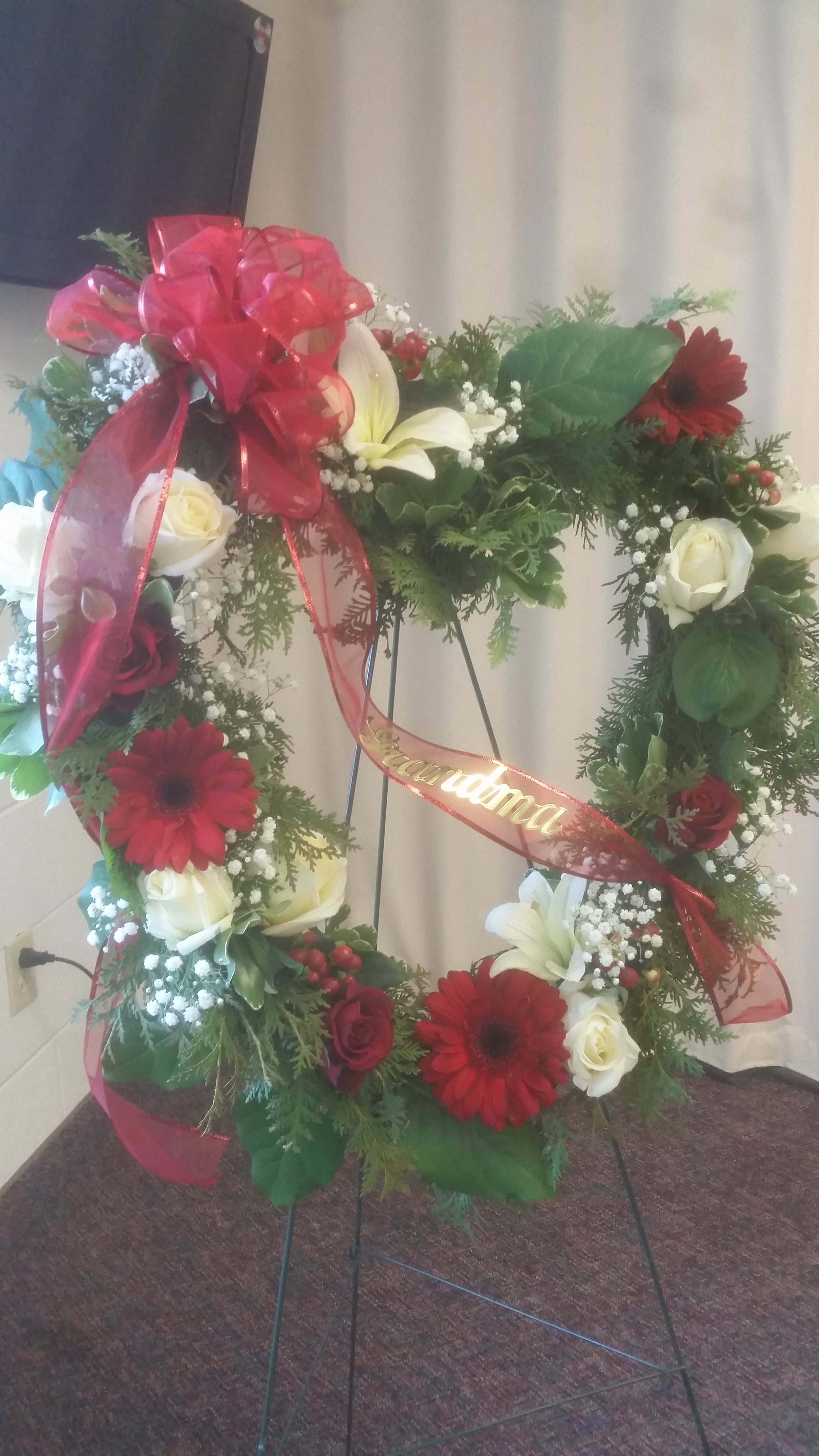 Loving Hearts Loving Hearts - This stunning floral heart includes roses, gerbera daisies, lilies, hypericum berries and baby's breath.