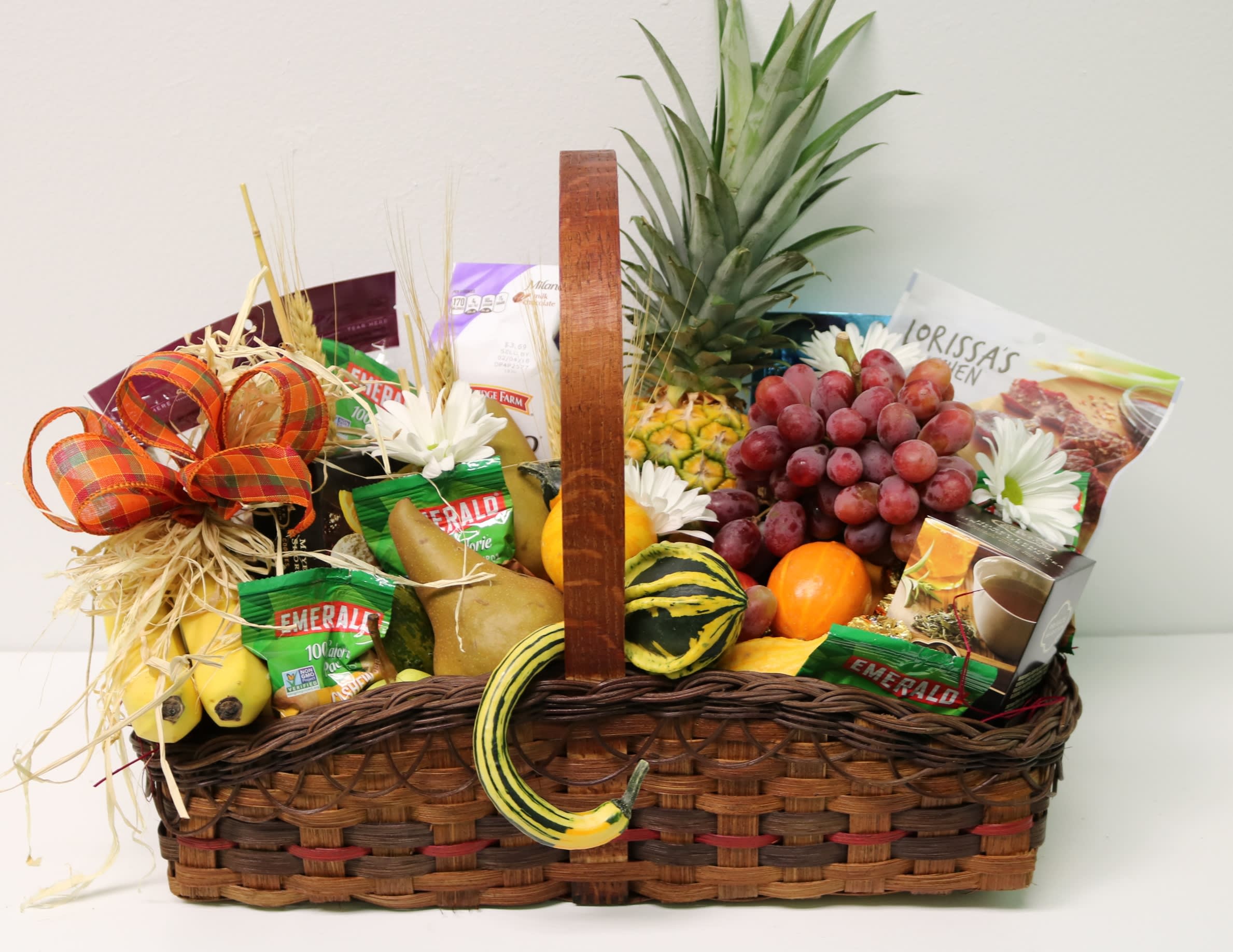 Gourmet Basket Gourmet Basket - Yummy! Everything your belly could desire is gathered together in this glorious fall gourmet basket. Nuts, fresh fruit, mouth watering cookies and so much more all presented beautifully in a rustic basket decorated with fresh flowers, wheat and a sweet fall bow.