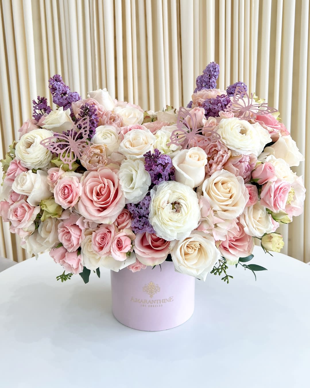 Sweet As A Butterfly - This beautiful flower arrangement features a mix of pink, purple, and white flowers. The flowers are  topped with cute butterflies, making it a charming gift fit for a princess.