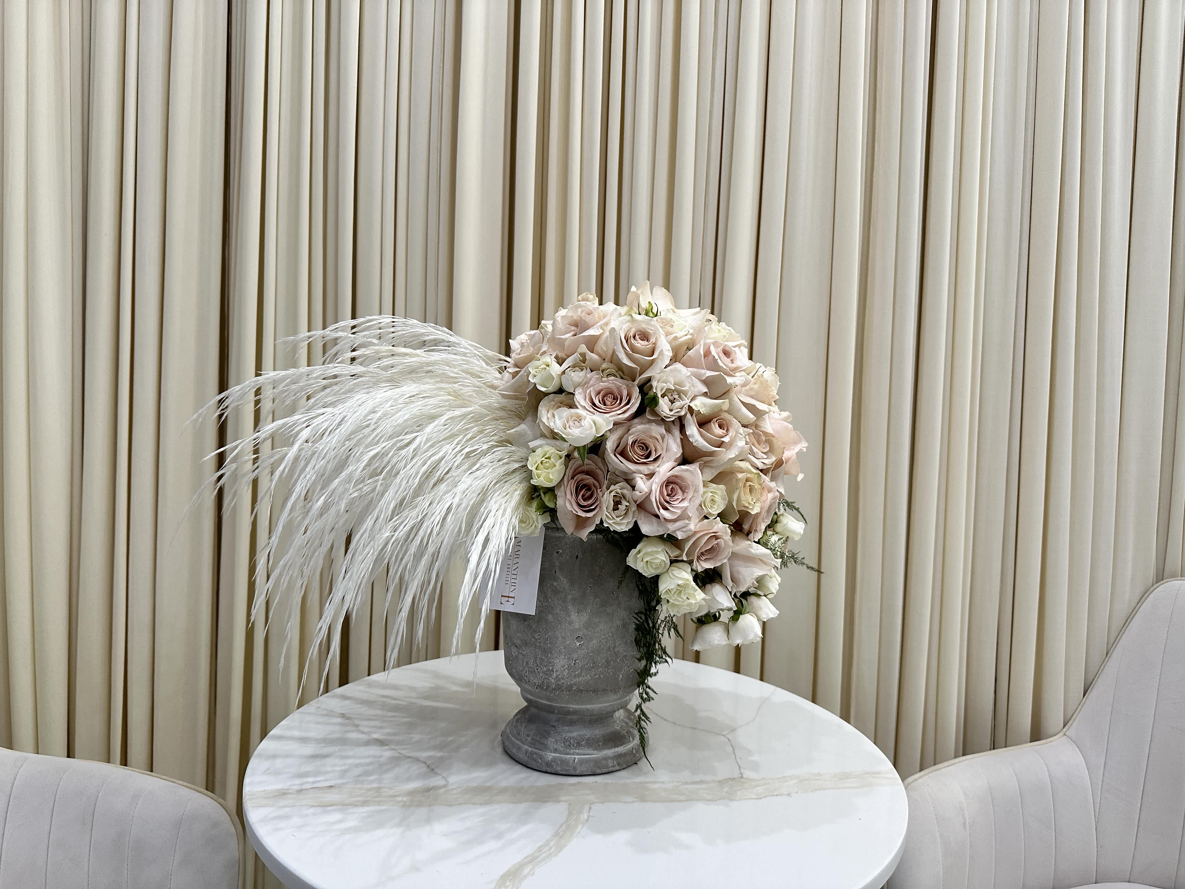 Natural Beauty - Bring the beauty of nature indoors with this stunning arrangement of ivory and blush roses and baby roses. The soft, neutral tones will complement any décor, and the delicate blooms will add a touch of freshness to your home.