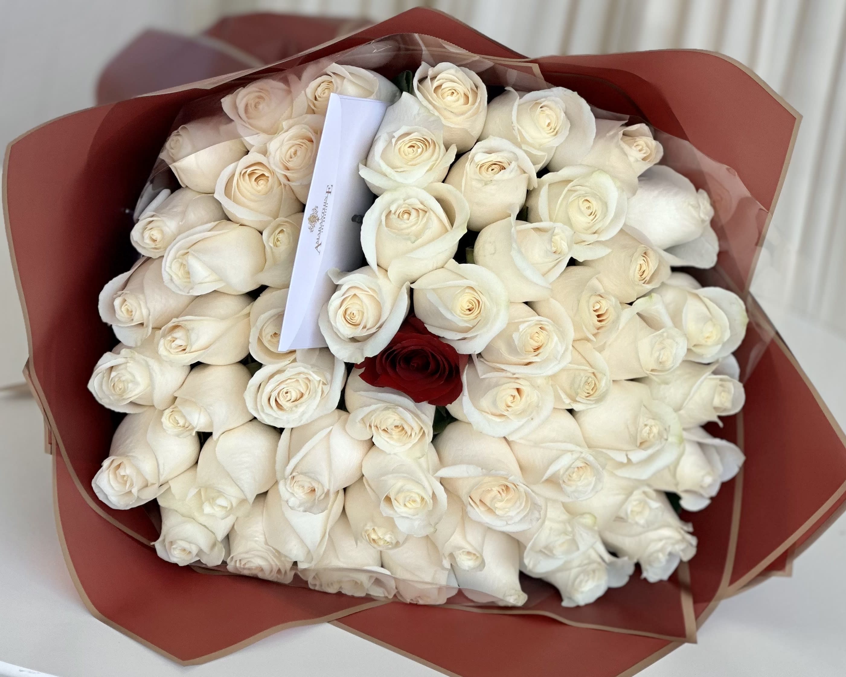 Eternal Love Bouquet - Celebrate the everlasting bond of love with our &quot;Eternal Love Bouquet.&quot; This enchanting arrangement features a mesmerizing display of pristine white roses, symbolizing pure love and devotion, with one single red rose nestled at its heart, representing a love that stands out from the rest. Wrapped in passionate red paper and adorned with a beautiful gold ribbon, this bouquet is a striking expression of love and admiration. Whether it's an anniversary, a special occasion, or a heartfelt gesture, the &quot;Eternal Love Bouquet&quot; is a timeless and elegant way to convey your deepest emotions. 