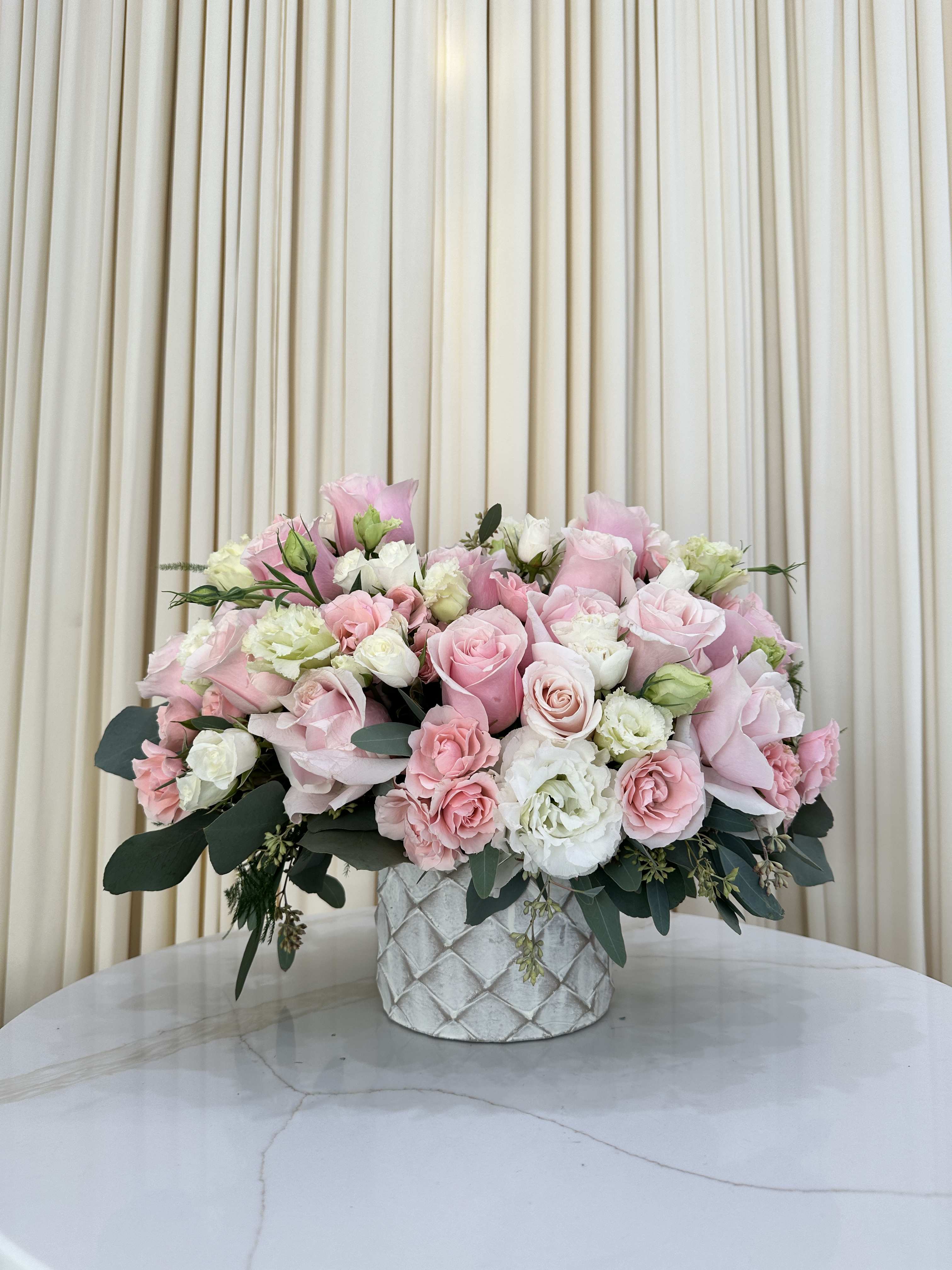 Pink &amp; Perfect - The epitome of elegance, this arrangement showcases a timeless combination of soft pink roses and crisp white baby roses. Each perfectly formed bloom is meticulously arranged to create a harmonious balance. Ideal for any occasion that calls for a touch of sophistication and timeless beauty.