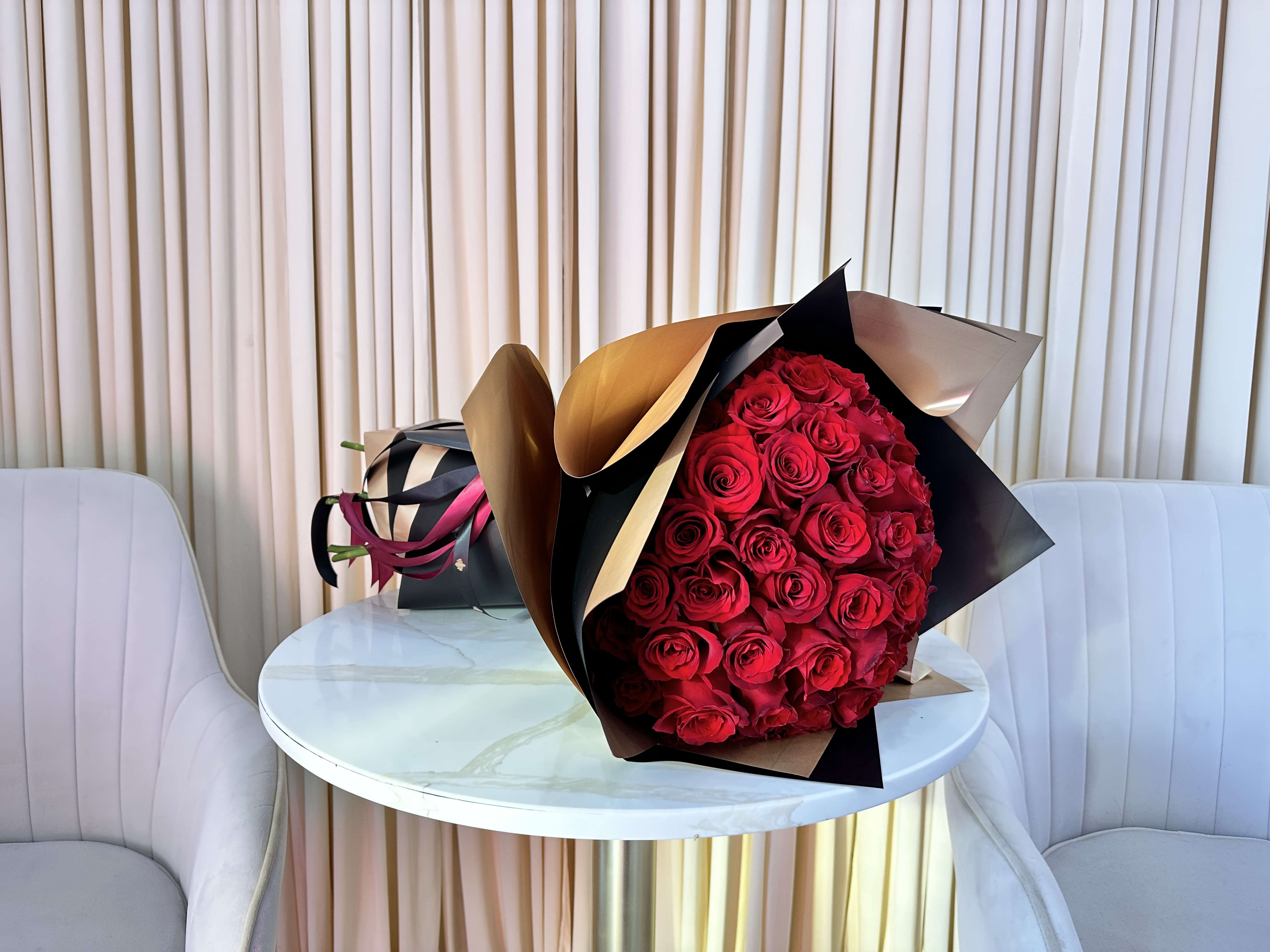 Fifty Shades of Red - Make a grand gesture of love and devotion with this magnificent bouquet of 50 stunning red roses. The vibrant blooms are sure to leave a lasting impression and express your deepest emotions.  
