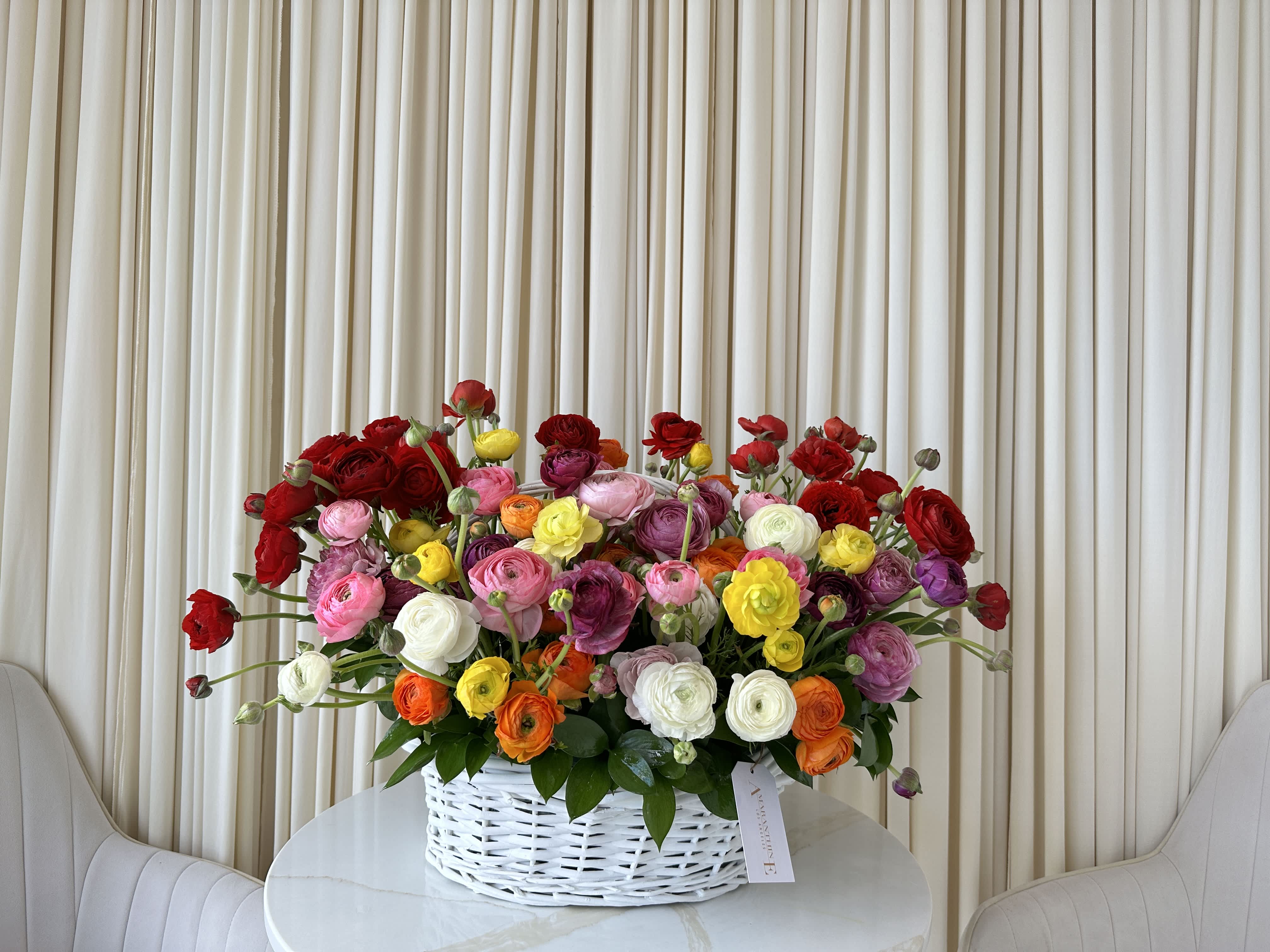 Spring's Promise - Ring in the new season with this delightful basket overflowing with colorful ranunculus blooms. Featuring a variety of vibrant ranunculus flowers, this basket embodies the promise of spring.  This delightful arrangement is a perfect way to celebrate the changing of the seasons or to bring a touch of springtime cheer to someone's home.