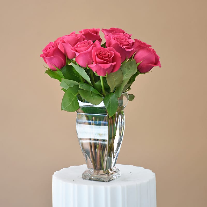 Pink Rose Passion - W606 - Send Pink Rose Passion to that special someone today and let them know you are thinking about them. Pink Rose Passion is a simple, classy flower arrangement that is made with 12 fresh hot pink Roses and is garnished with lemon leaves in a couture clear glass vase. Dimensions Approximately: 11.5&quot; H x 6.5&quot; W
