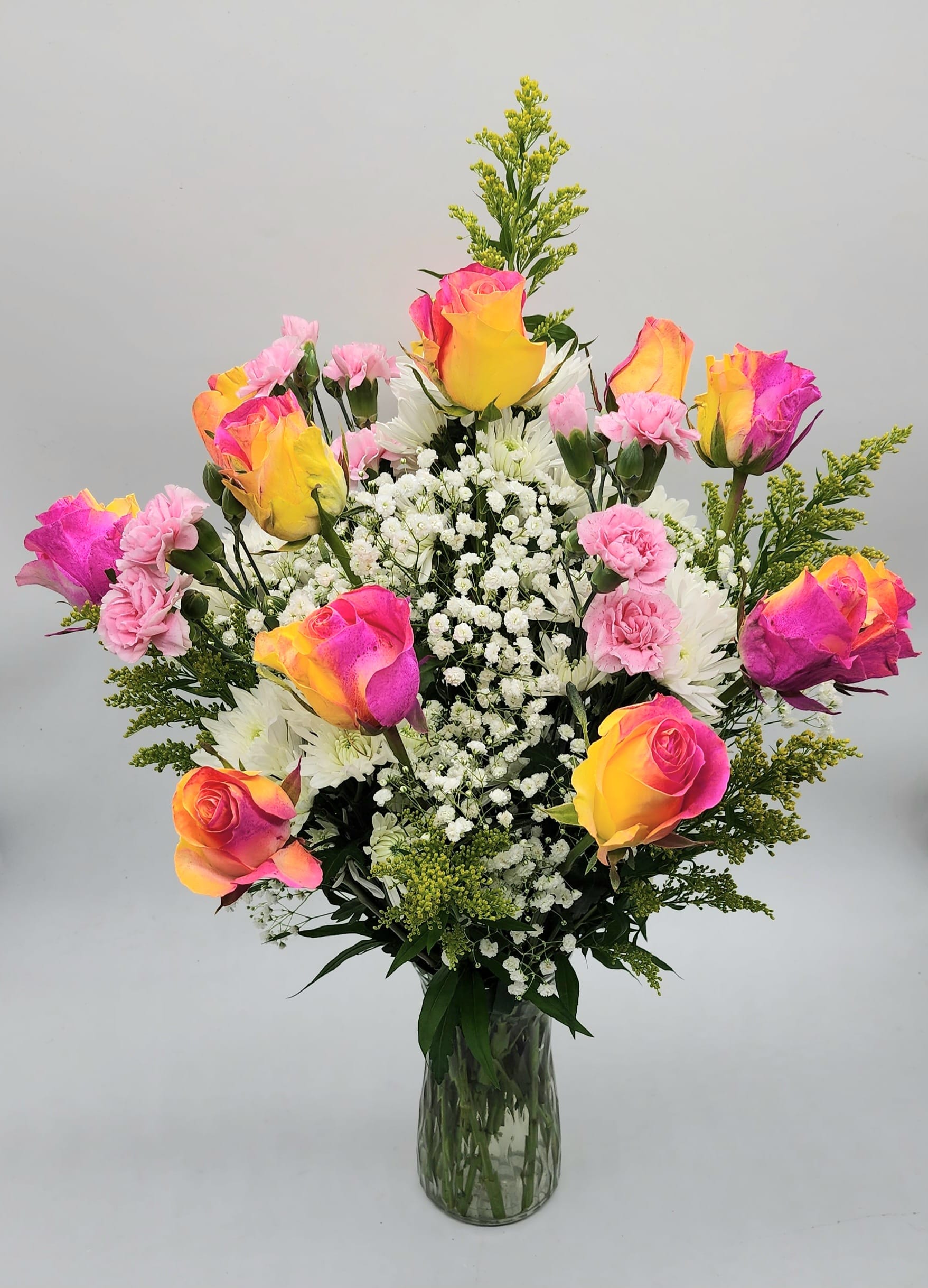 "Fierce Love" Dozen Rose Arrangement "Fierce Love" Dozen Rose Arrangement - A Dozen Designer Choice Roses with Spring flowers in a glass vase, made for that special someone!