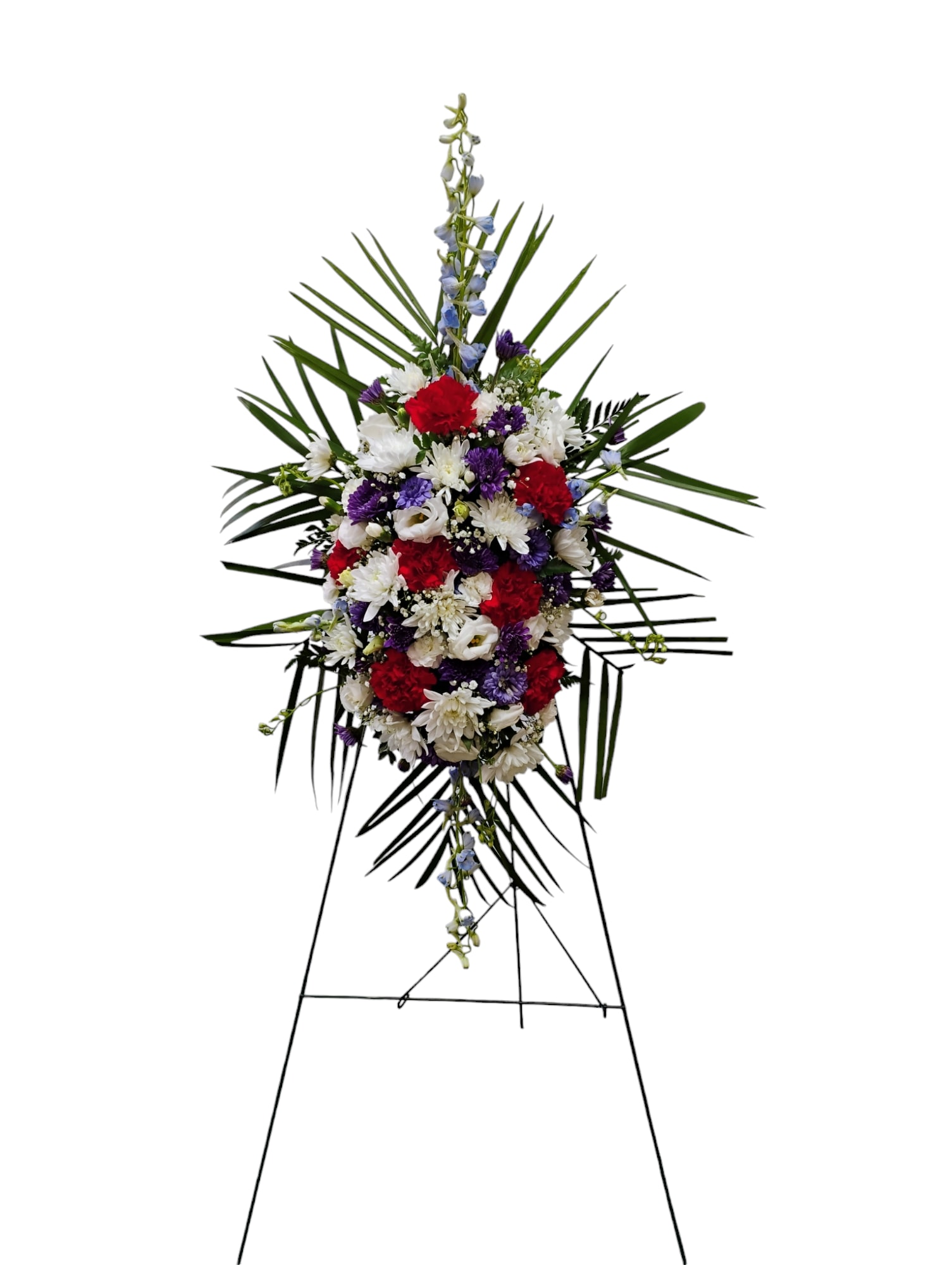 Patriotic Rememberance - The Patriotic Remembrance easel spray is a stunning tribute that beautifully embodies the spirit of our nation through its vibrant red, white, and blue floral arrangement. This exquisite piece is expertly crafted with a harmonious blend of delphinium, carnations, roses, pomss, and lisianthus, each flower thoughtfully selected to represent the colors of the American flag. The design not only serves as a visual celebration of patriotism but also conveys deep respect and honor for those being remembered.  &nbsp;Customization options are available, allowing for a personalized touch that closely resembles the provided image, ensuring that each arrangement is unique and tailored to your specific needs. Please note that due to the natural variations in flowers, some color substitutions may be necessary, and the availability of seasonal blooms may affect pricing.