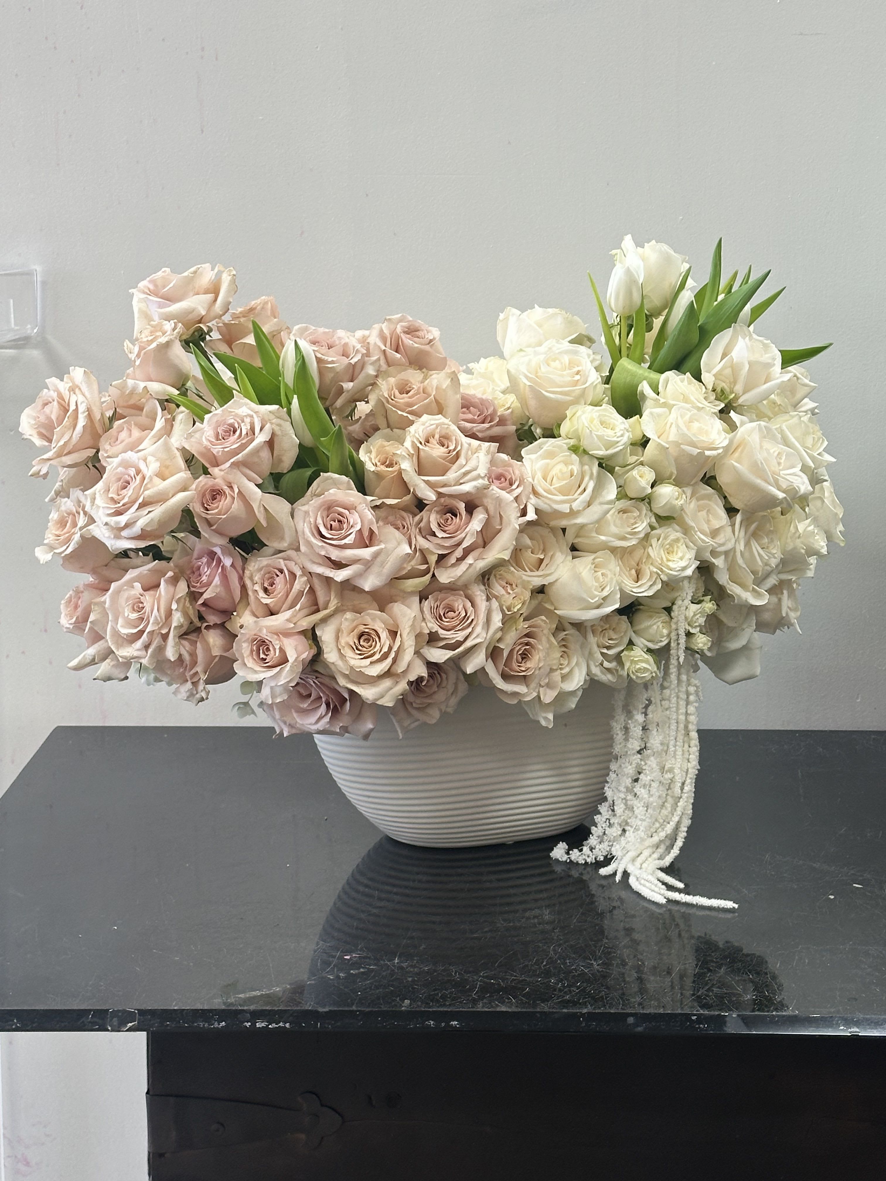 Classic Charm Classic Charm - Charming and elegant this classic arrangement displays full and dense floral arrangement full of roses. White roses are complimented with an earthy pallet for warmth and texture, a stem of dried amaranthus for final touch of sophistication Some florals are seasonal, if particular flower will not be available due to season, we will substitute for similar flower, composition, color pallet and value of the arrangements as closely as possible. All effort to create a floral arrangement as close to the photo shown, the actual arrangement may vary slightly in its appearance from the photo shown. If you have any questions about your order, we welcome you to call us in or email